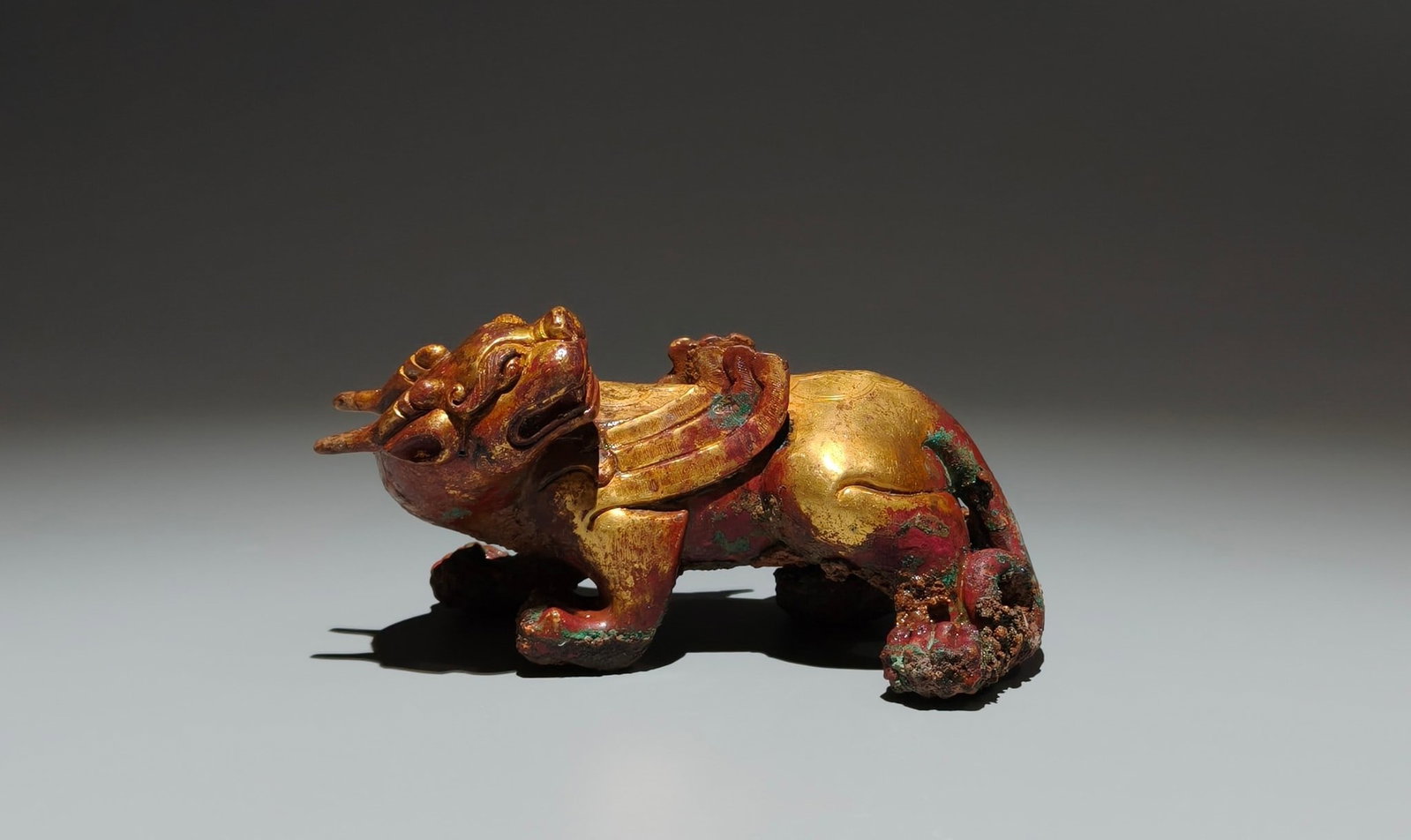 An Exquisite Gilt Bronze Auspicious Beast Ornament: Estimated Value:1500-3000 An Exquisite Gilt Bronze Auspicious Beast Ornament,the Warring States period in China,Size:3inx5.5inx2.4in