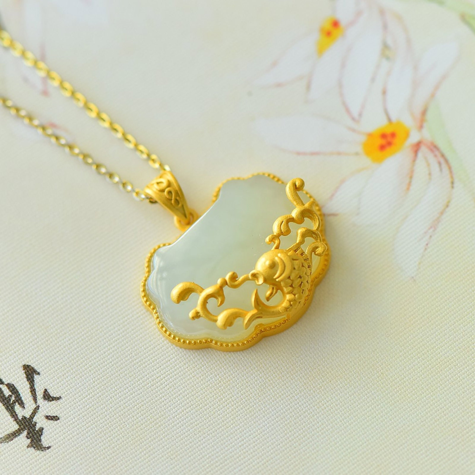 An Exquisite Sterling Silver-Gold Plated Inlaid White Jade Pendant: Estimated Value:300-600 An Exquisite Sterling Silver-Gold Plated Inlaid White Jade Pendant 纯银镀金镶白玉吊坠