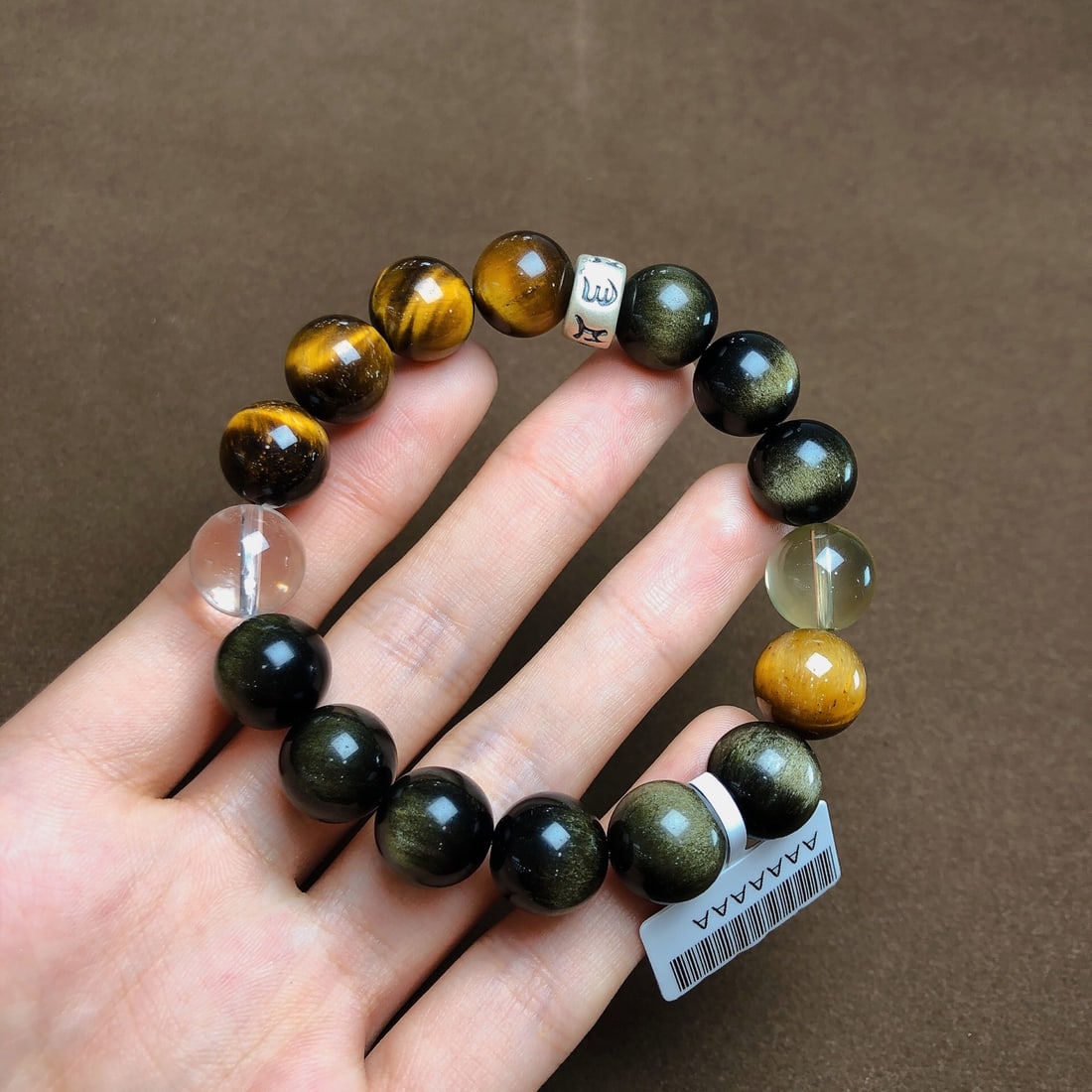 An Exquisite Crystal Gold Obsidian Bracelets: Estimated Value:300-600 An Exquisite Crystal Gold Obsidian Bracelets,Size:12mm,Weight:38.3g 水晶金曜石手串