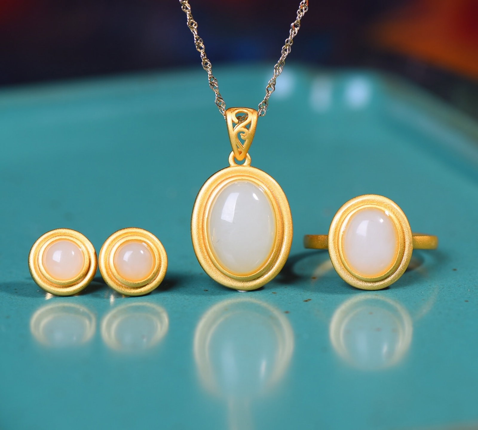 A Set of Fine Sterling Silver-Gold Plated Inlaid White Jade Jewelrys: Estimated Value:400-800 A Set of Fine Sterling Silver-Gold Plated Inlaid White Jade Jewelrys,Size:(Ring)8mmx10mm,(Earrings)6mmx6mm,(Pendant)10mmx14mm