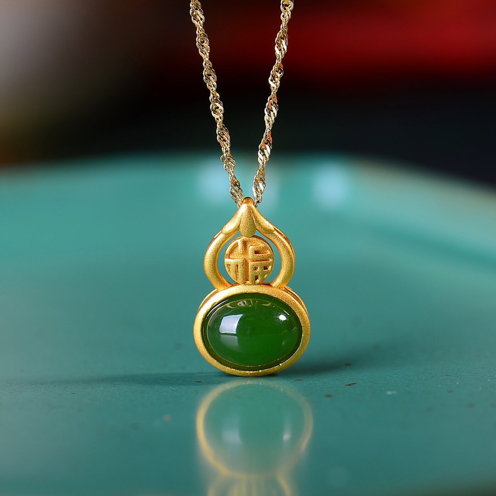 An Exquisite Sterling Silver-Gold Plated Inlaid Jasper Gourd Pendant: Estimated Value:300-600 An Exquisite Sterling Silver-Gold Plated Inlaid Jasper Gourd Pendant,Size:8mmx10mm 纯银镀金镶碧玉葫芦吊坠