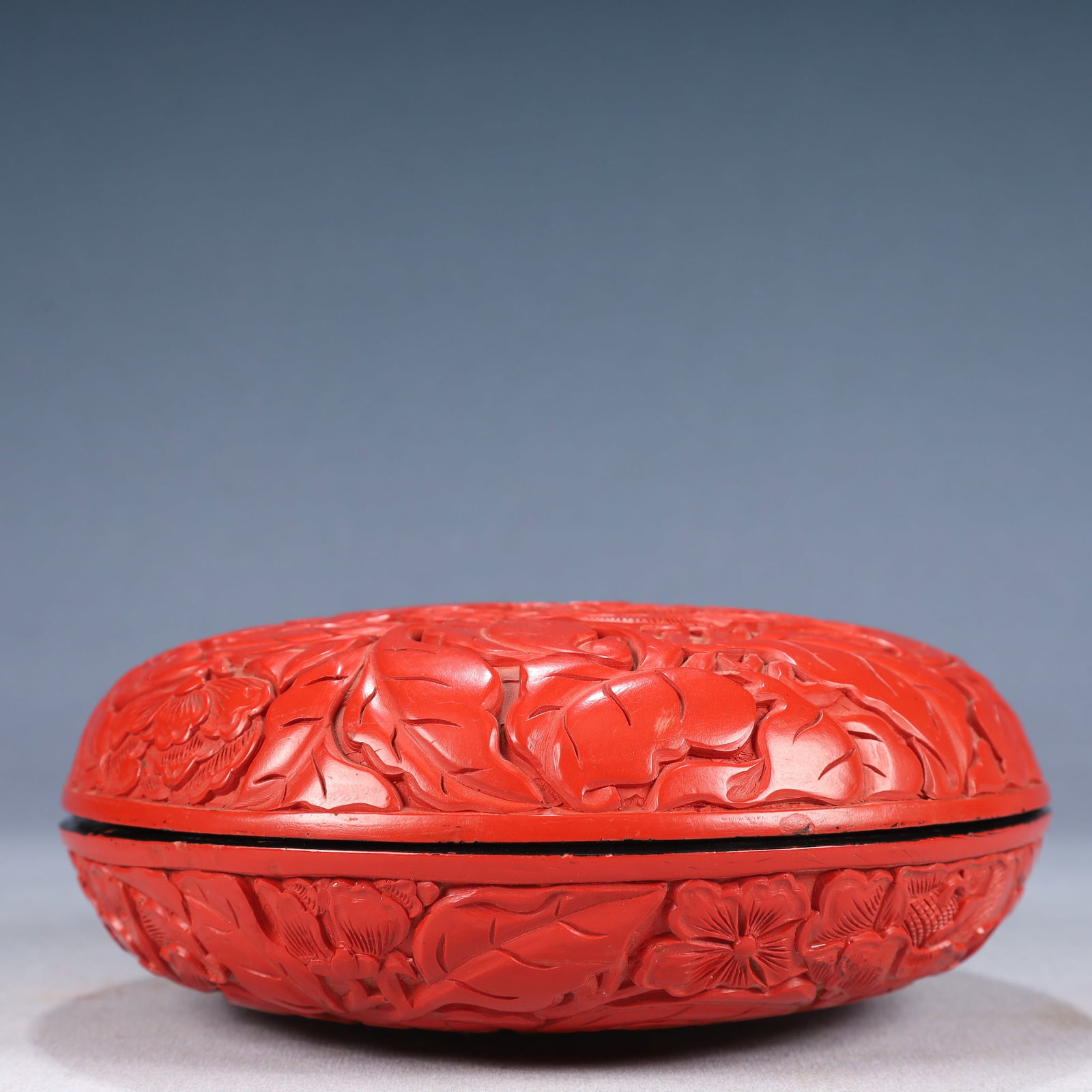 An Exquisite Carved Red Lacquer Flower Pattern Cover Box: Estimated Value:2000-4000 An Exquisite Carved Red Lacquer Flower Pattern Cover Box,Qing Dynasty, China,Size:6.9inx2.8in,Weight:750g