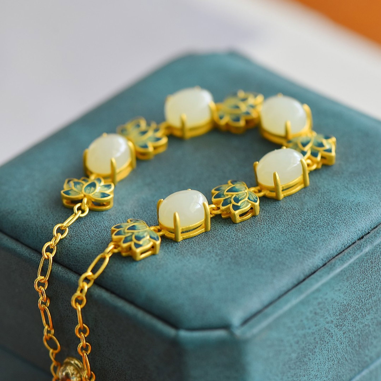 An Exquisite Sterling Silver-Gold Plated Inlaid White Jade Enamel Bracelet: Estimated Value:400-800 An Exquisite Sterling Silver-Gold Plated Inlaid White Jade Enamel Bracelet,Size:7mmx9mm 纯银镀金镶白玉珐琅手链
