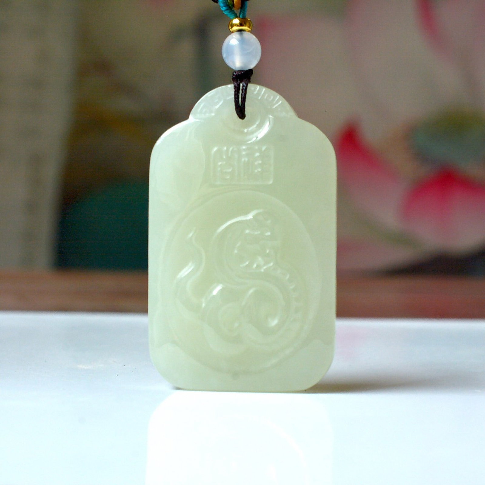 An Exquisite White Jade Auspicious Cloud and Snake Pattern Pendant: Estimated Value:800-1600 An Exquisite White Jade Auspicious Cloud and Snake Pattern Pendant,Size:30mmx49mm (寓意)吉祥 又名小龙