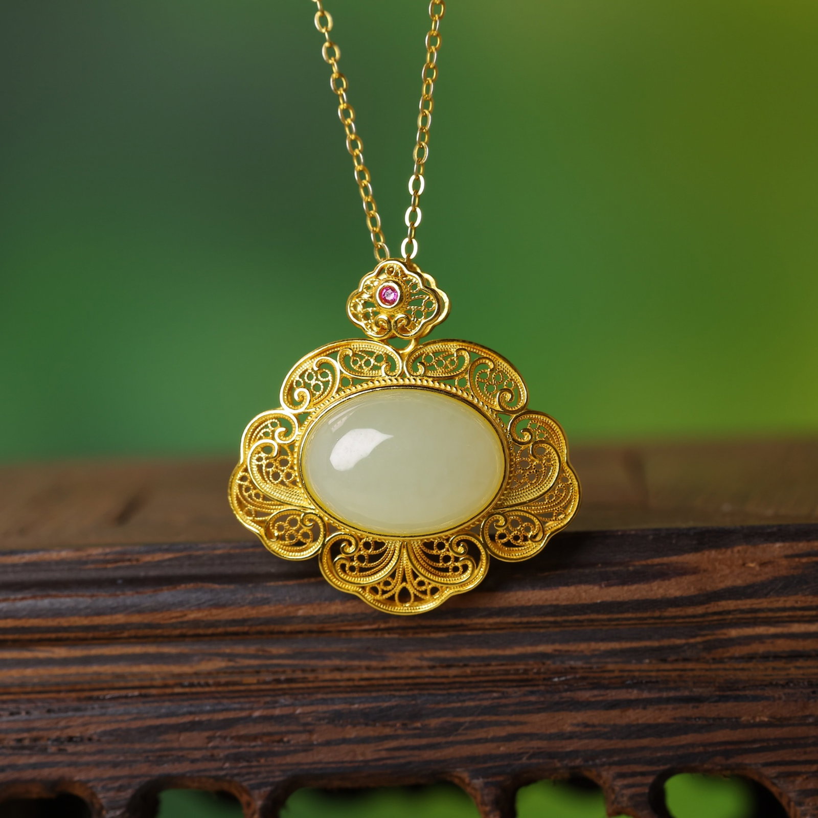 An Exquisite Sterling Silver-Gold Plated Inlaid White Jade Pendant: Estimated Value:300-600 An Exquisite Sterling Silver-Gold Plated Inlaid White Jade Pendant,Size:10mmx14mm 纯银镀金镶白玉吊坠