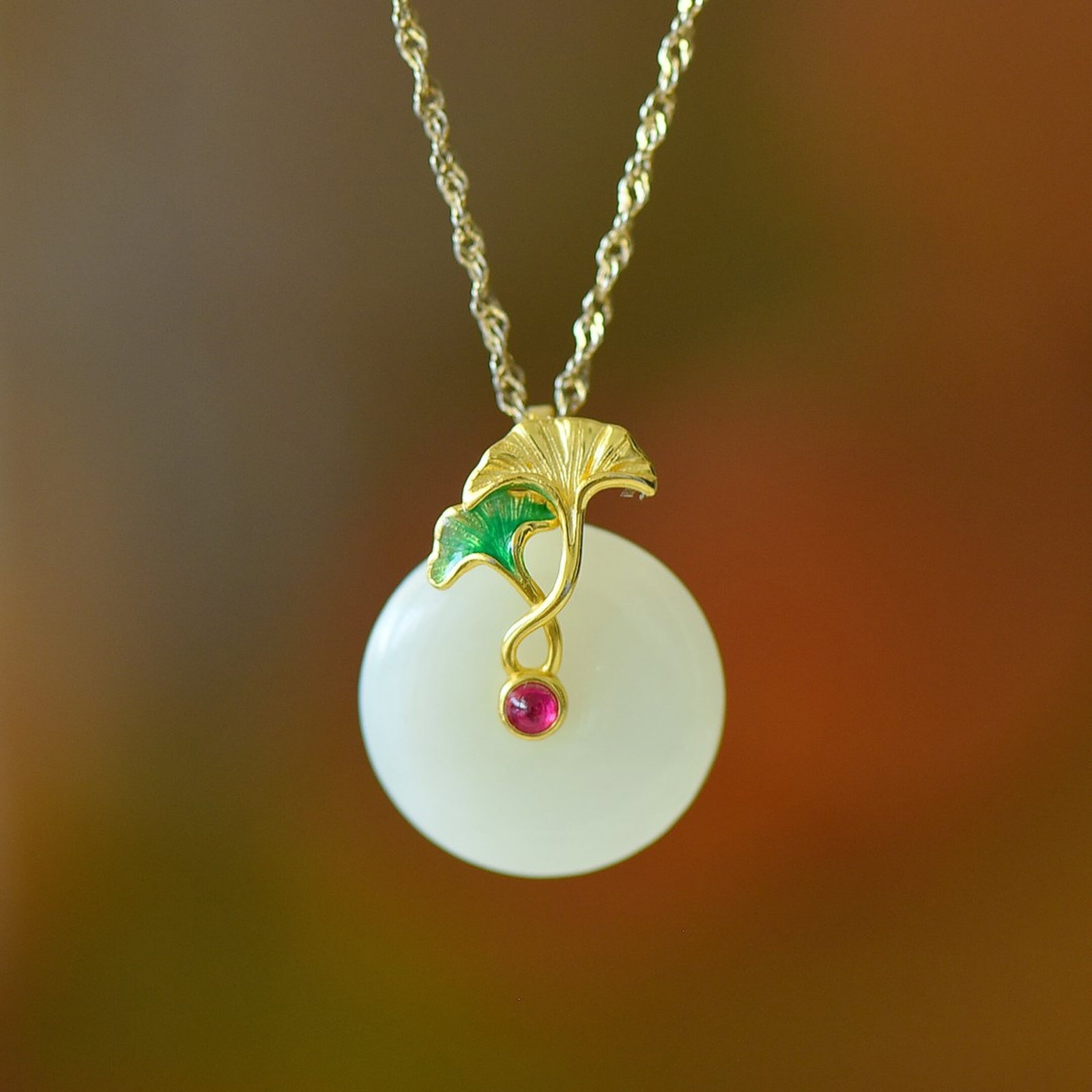 An Exquisite Sterling Silver-Gold Plated Inlaid White Jade Pendant: Estimated Value:200-400 An Exquisite Sterling Silver-Gold Plated Inlaid White Jade Pendant 纯银镀金镶白玉吊坠