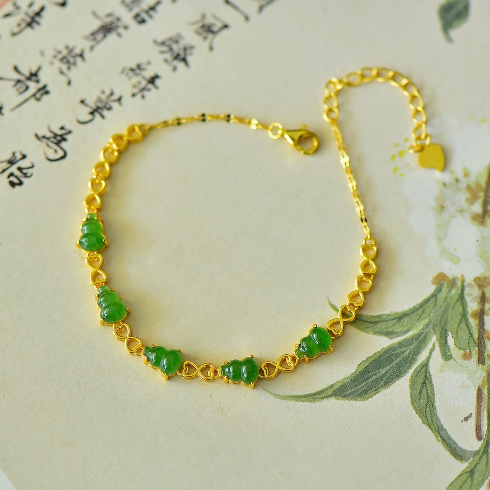 An Exquisite Sterling Silver-Gold Plated Inlaid Jasper Gourd Bracelets: Estimated Value:400-800 An Exquisite Sterling Silver-Gold Plated Inlaid Jasper Gourd Bracelets,Size:5mmx7mm 纯银镀金镶碧玉葫芦手链