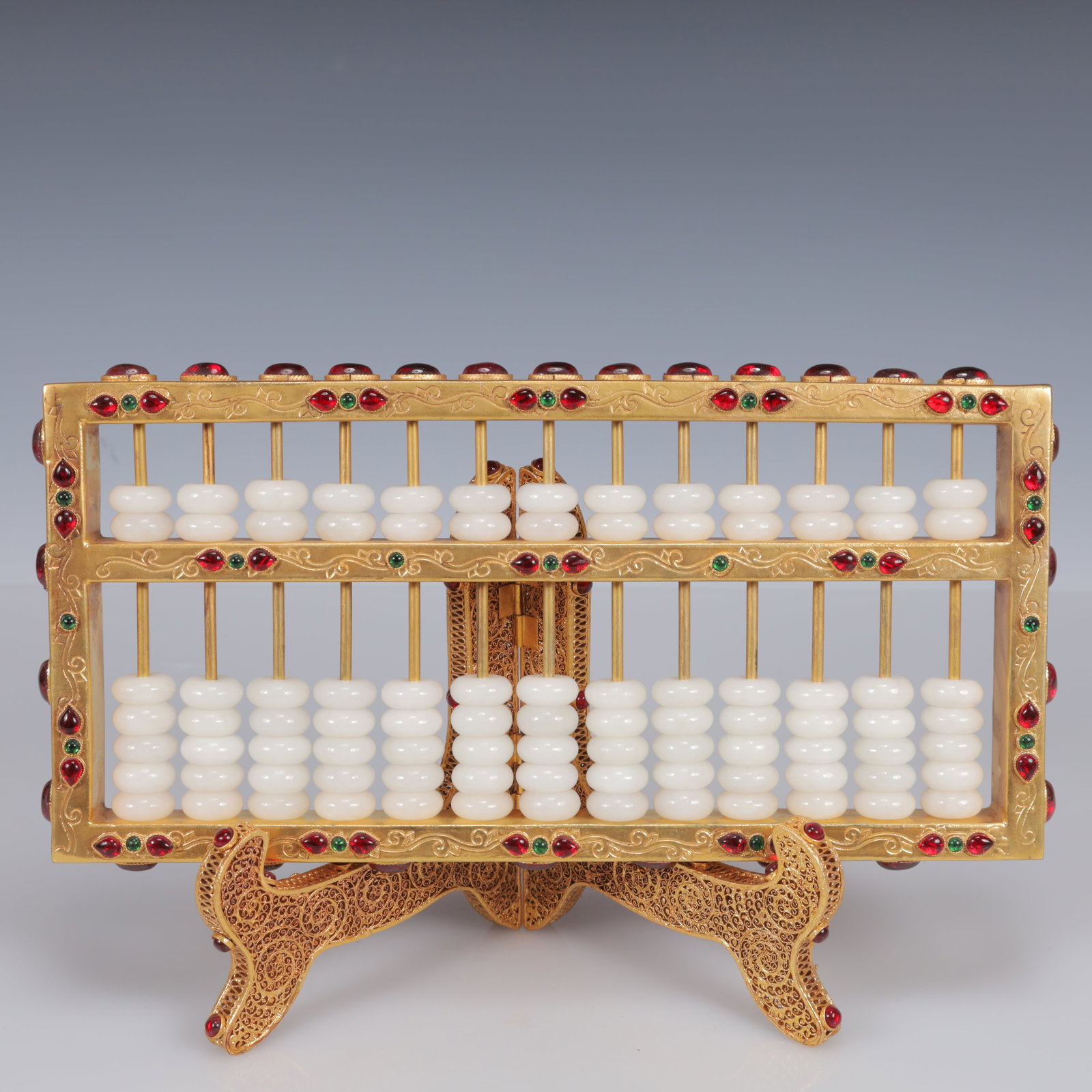 An Exquisite Filigree and Gilding Inlaid White Jade Suanpan,Inlaid Gems: Estimated Value:3800-7600 An Exquisite Filigree and Gilding Inlaid White Jade Suanpan,Inlaid Gems,Qing Dynasty, China,Qianlong Four-Character Mark,Size:11.8inx4.3inx7.5in,Weight:1500g
