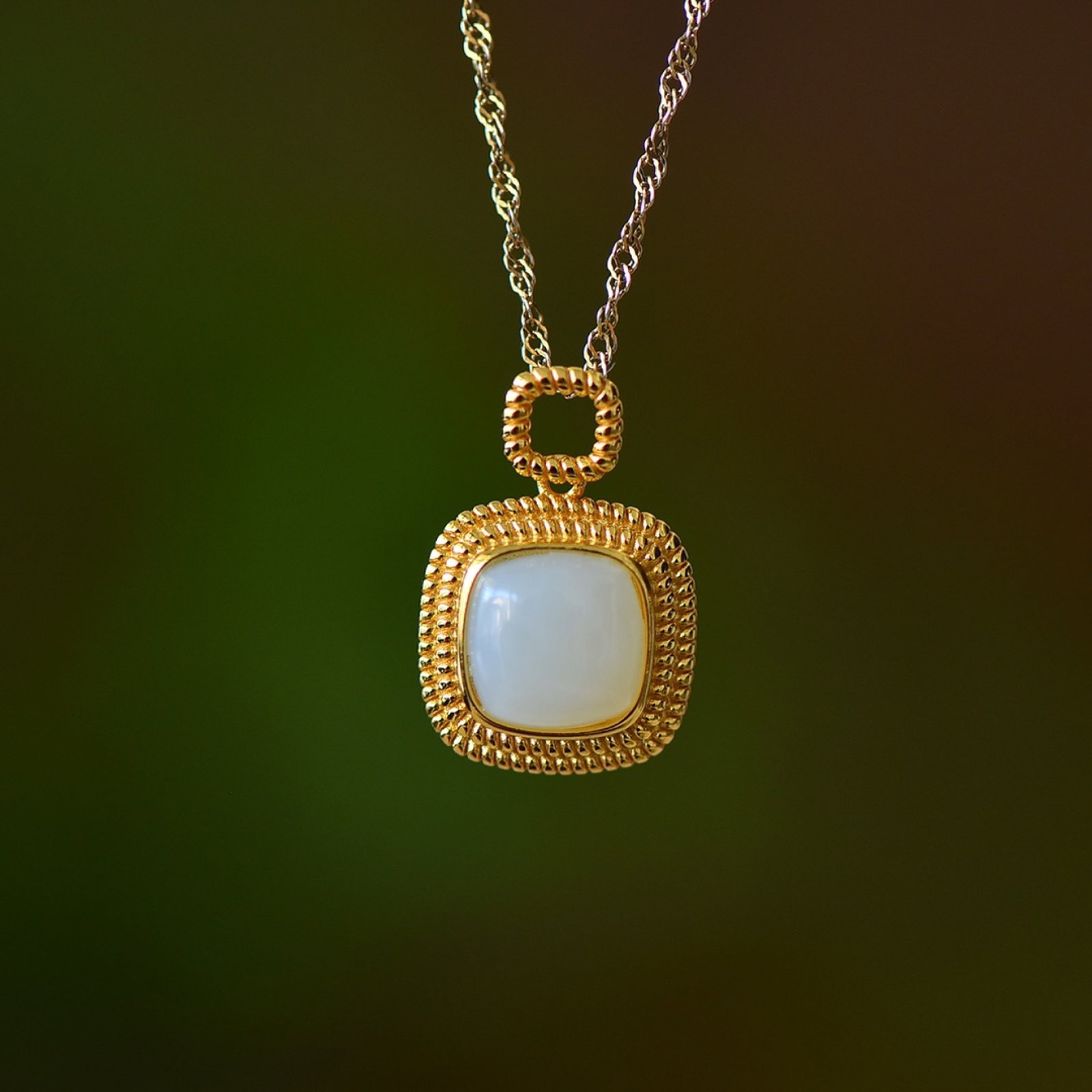 An Exquisite Sterling Silver-Gold Plated Inlaid White Jade Pendant: Estimated Value:200-400 An Exquisite Sterling Silver-Gold Plated Inlaid White Jade Pendant,Size:8mmx8mm 纯银镀金镶白玉吊坠