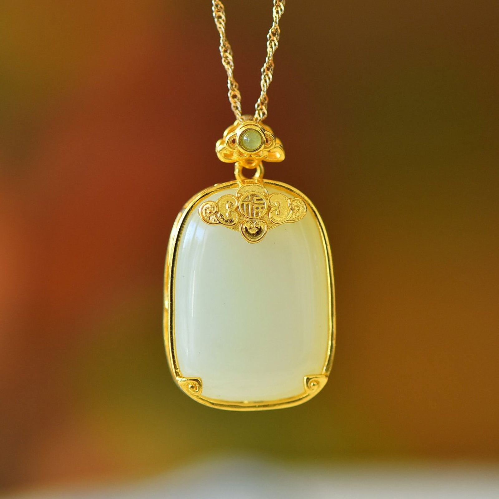 An Exquisite Sterling Silver-Gold Plated Inlaid White Jade Pendant: Estimated Value:300-600 An Exquisite Sterling Silver-Gold Plated Inlaid White Jade Pendant,Size:18mmx25mm 纯银镀金镶白玉吊坠