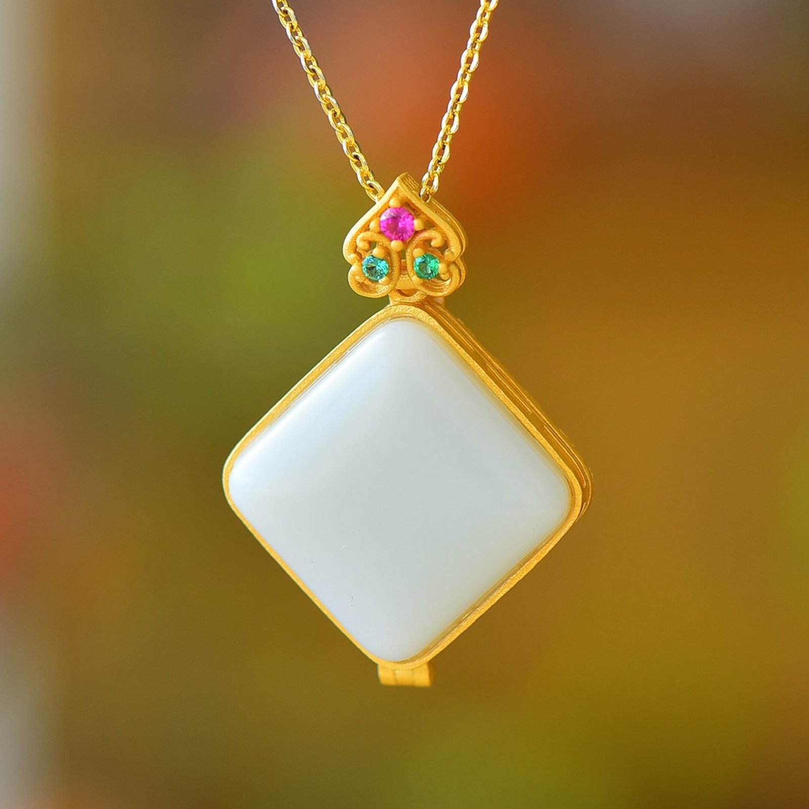 An Exquisite Sterling Silver-Gold Plated Inlaid White Jade Pendant: Estimated Value:300-600 An Exquisite Sterling Silver-Gold Plated Inlaid White Jade Pendant 纯银镀金镶白玉吊坠