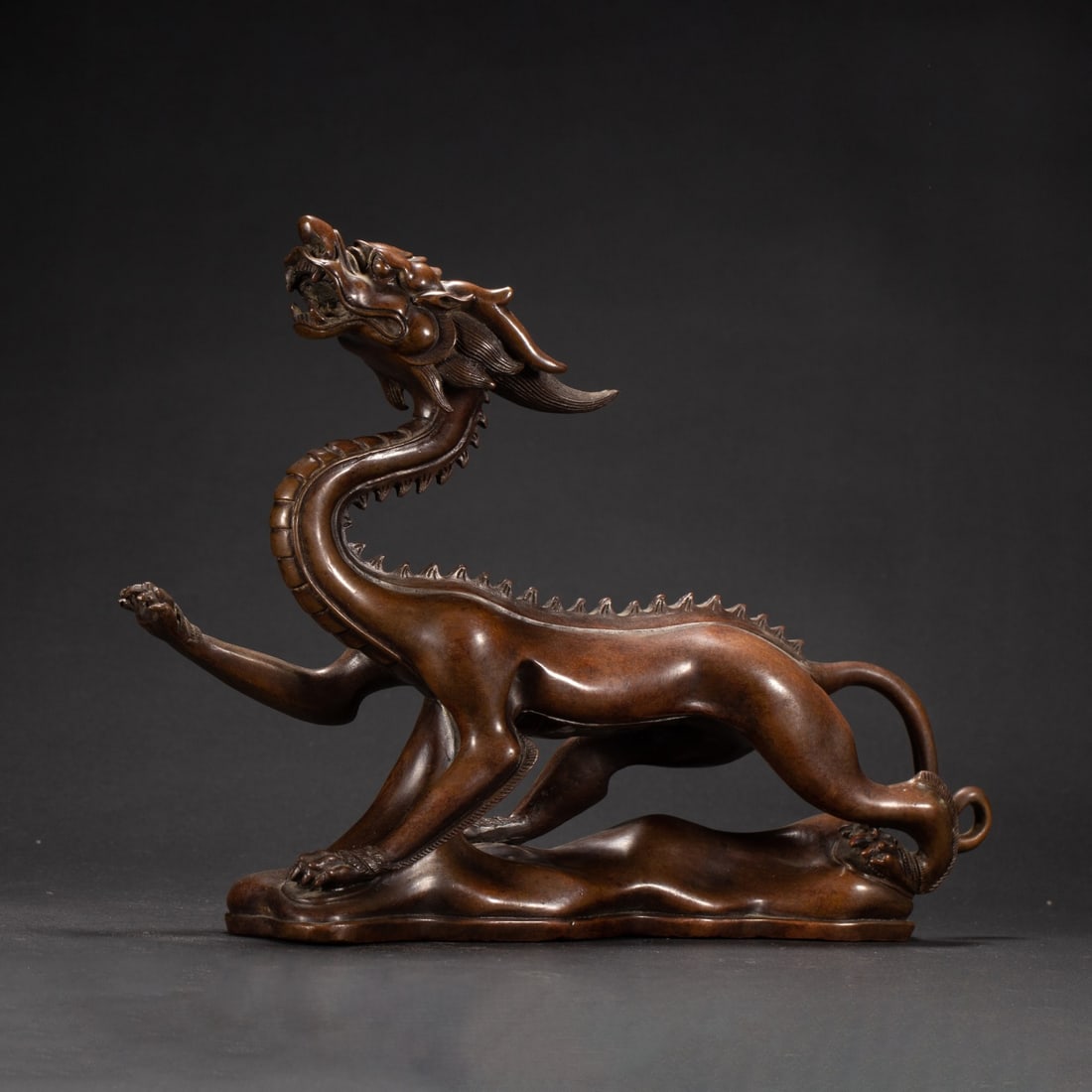 A Exquisite Bronze Dragon Ornament: A Exquisite Bronze Dragon Ornament,Ming Dynasty, China,Size:11.8inx3.1in,Height:9.1in,Weight:2180g 铜龙摆件,中国明代
