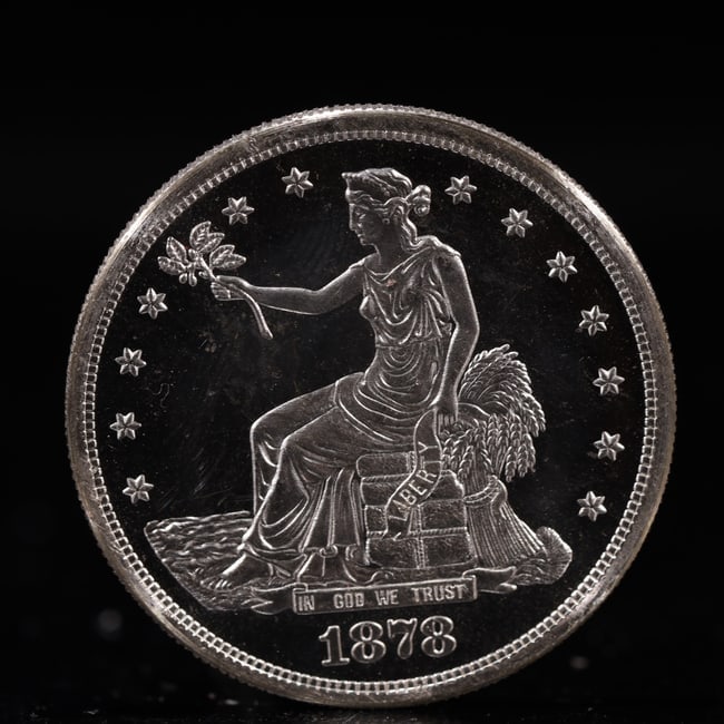 American coin. Obverse: Liberty seated on a pedestal facing the sea to the left holding olive (1 of 2)