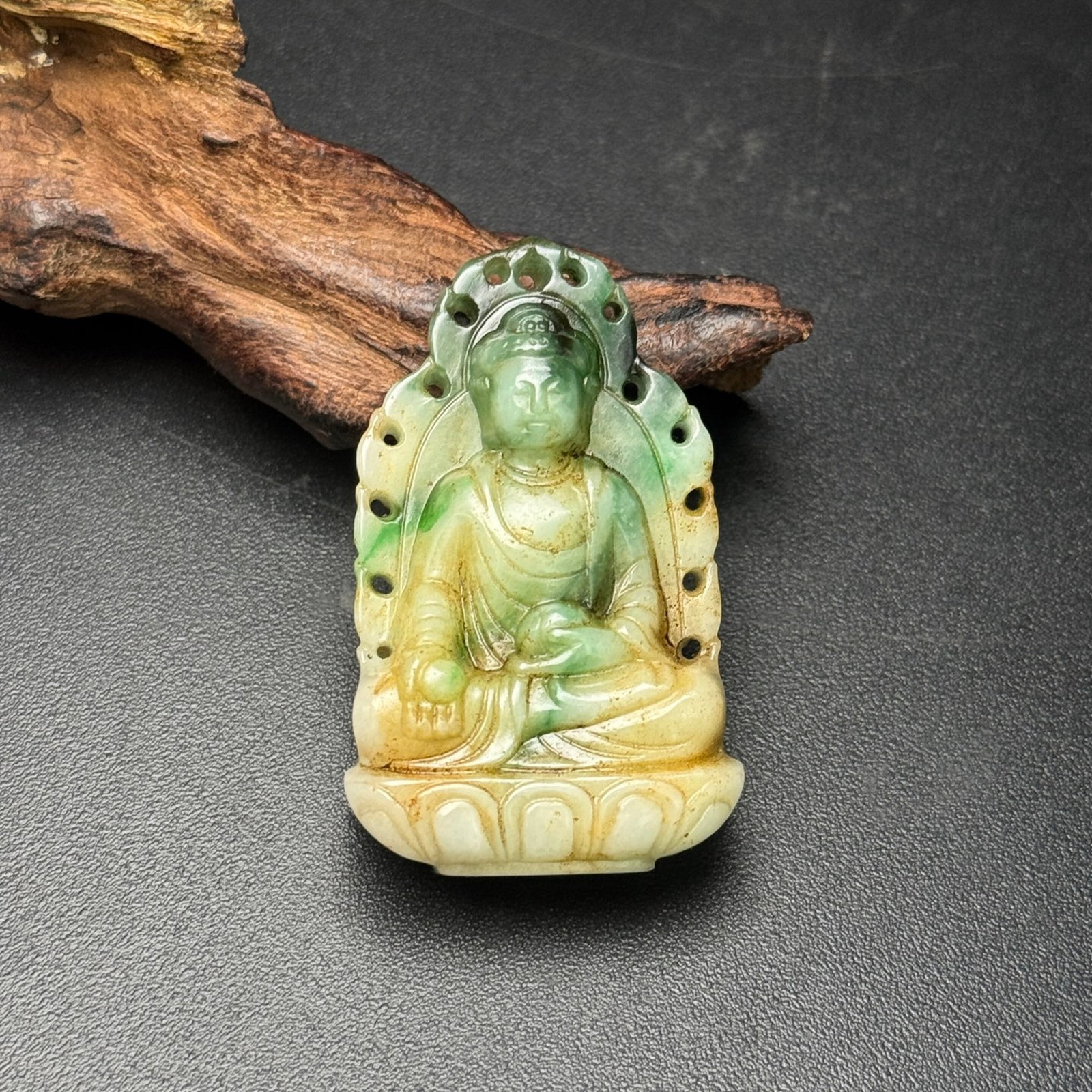 An Exquisite Jadeite Buddha Statue Pattern Pendant: Estimated Value:300-600 An Exquisite Jadeite Buddha Statue Pattern Pendant,Qing Dynasty,China,Size:30mmx49mmx12mm,Weight:32g