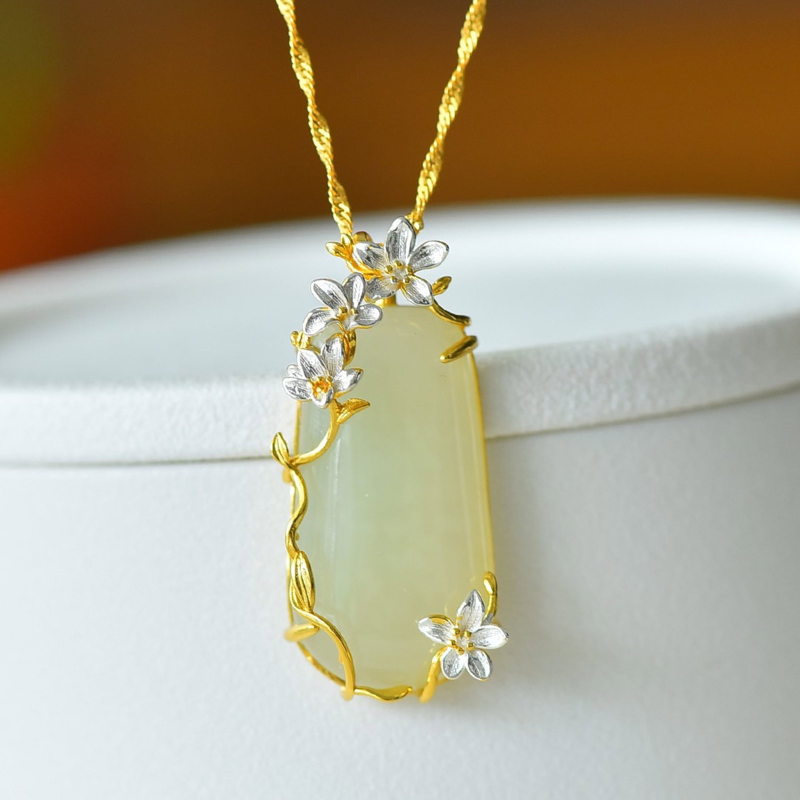 An Exquisite Sterling Silver-Gold Plated Inlaid White Jade Pendant: Estimated Value:300-600 An Exquisite Sterling Silver-Gold Plated Inlaid White Jade Pendant,Size:15mmx30mm 纯银镀金镶白玉吊坠