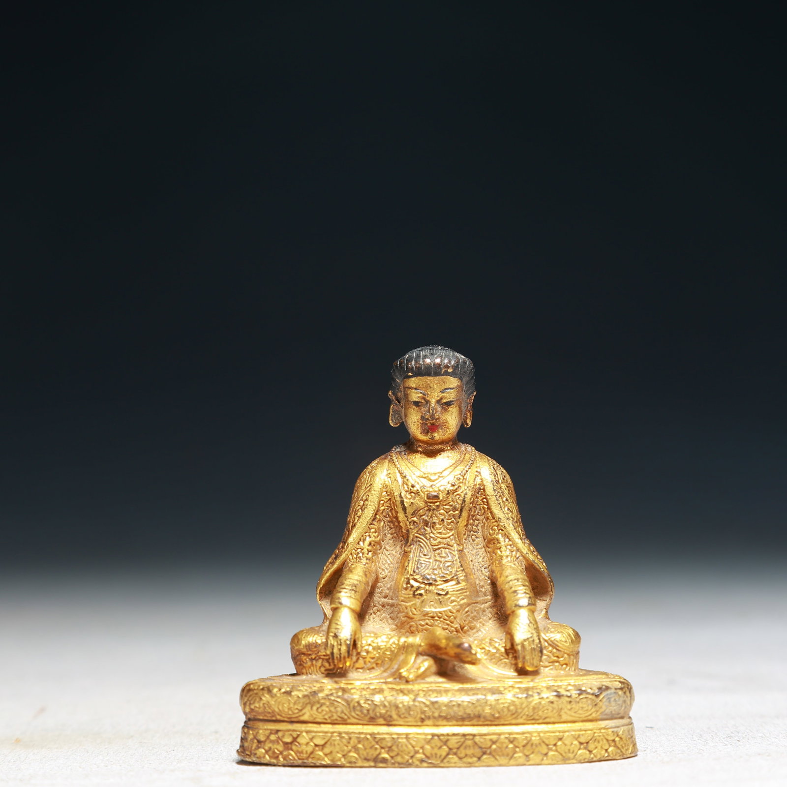 A Solemn Gilt Bronze Statue of Sakyamuni: Estimated Value:1100-2200 A Solemn Gilt Bronze Statue of Sakyamuni,Qing Dynasty,China,Size:2inx1.4inx2.2in,Weight:100g 铜鎏金如来像,中国清代