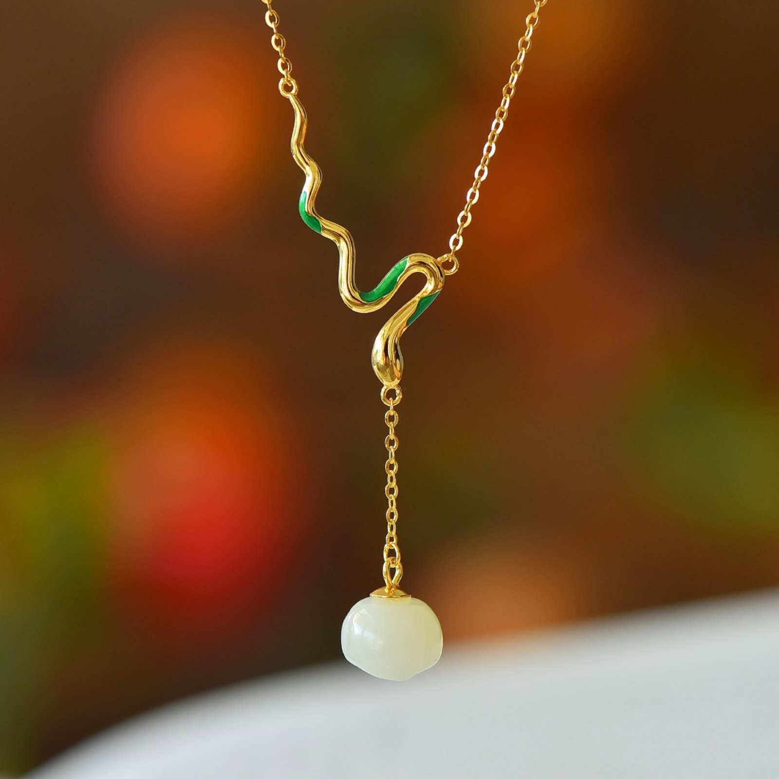 An Exquisite Sterling Silver-Gold Plated Inlaid White Jade Pendant: Estimated Value:200-400 An Exquisite Sterling Silver-Gold Plated Inlaid White Jade Pendant,Size:10mmx10mm 纯银镀金镶白玉吊坠