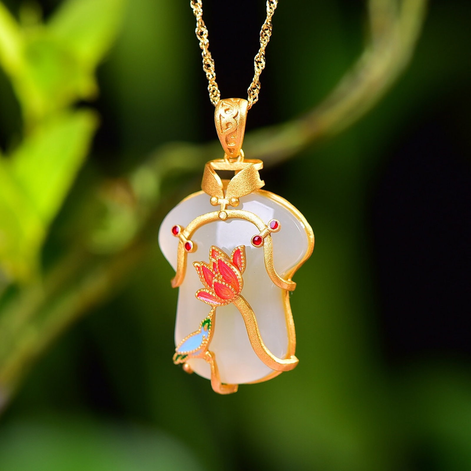 An Exquisite Sterling Silver-Gold Plated Inlaid White Jade Enamel Pendant: Estimated Value:400-800 An Exquisite Sterling Silver-Gold Plated Inlaid White Jade Enamel Pendant,Size:21mmx25mm 纯银镀金镶白玉珐琅吊坠