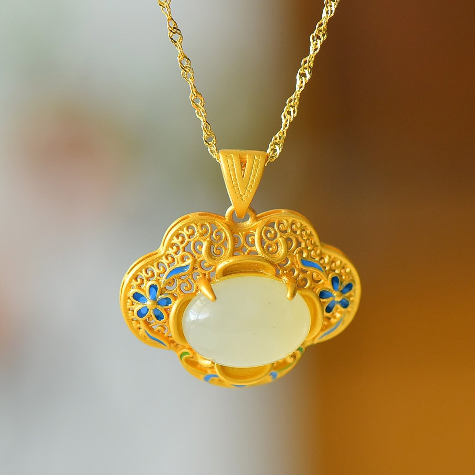An Exquisite Sterling Silver-Gold Plated Inlaid White Jade Enamel Pendant: Estimated Value:200-400 An Exquisite Sterling Silver-Gold Plated Inlaid White Jade Enamel Pendant 纯银镀金镶白玉珐琅吊坠