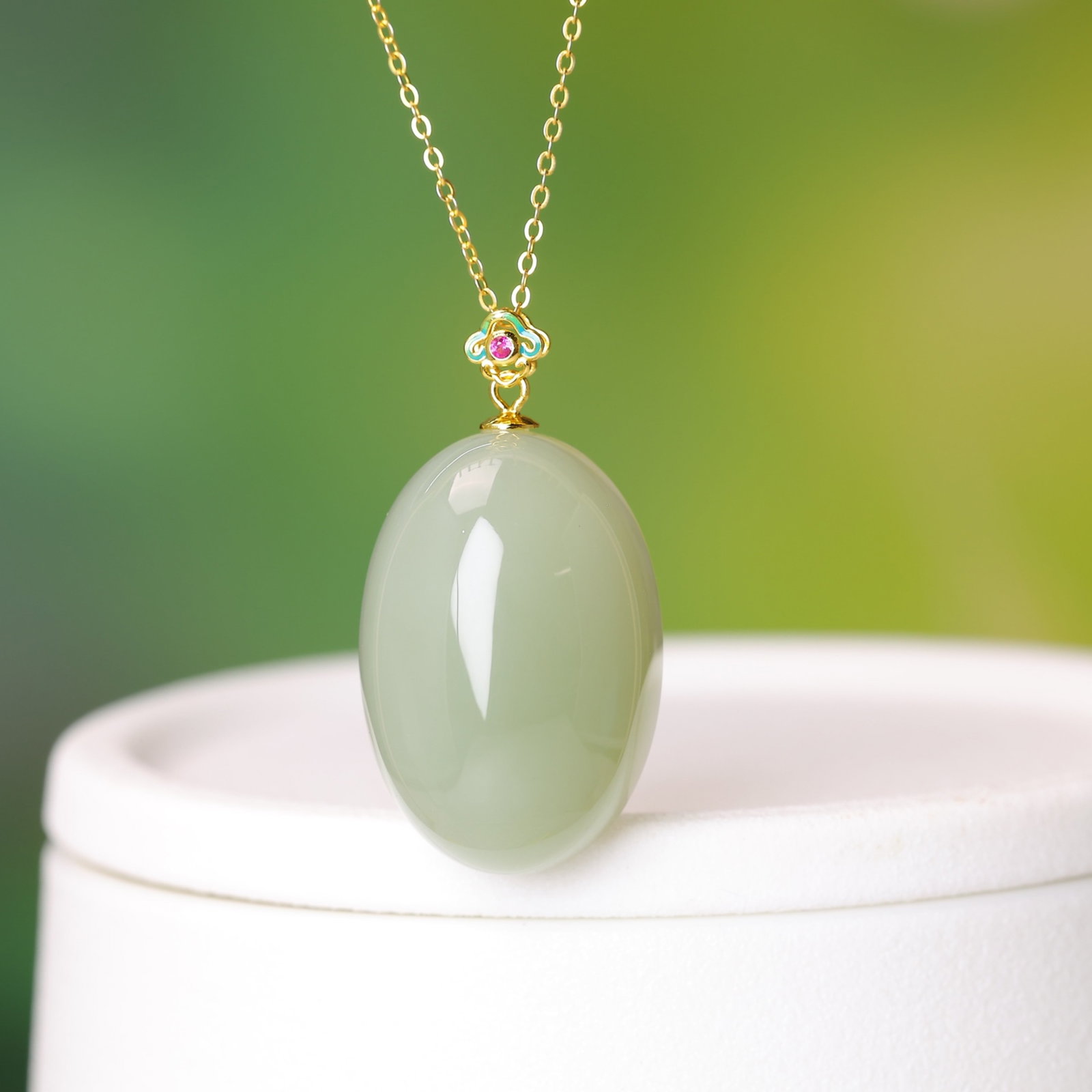 An Exquisite Sterling Silver-Gold Plated Inlaid White Jade Pendant: Estimated Value:720-1440 An Exquisite Sterling Silver-Gold Plated Inlaid White Jade Pendant,Size:20mmx30mm 纯银镀金镶白玉吊坠
