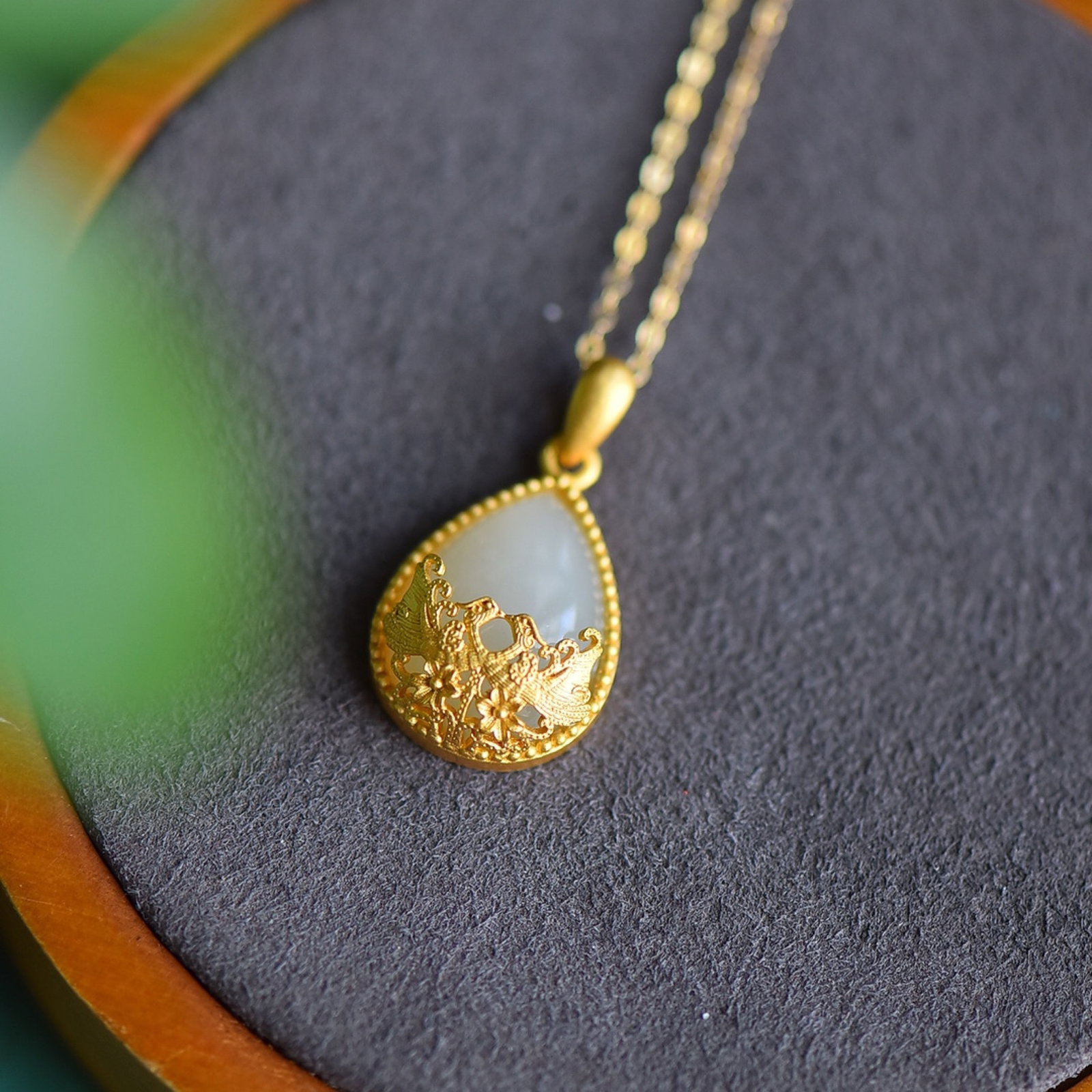 An Exquisite Sterling Silver-Gold Plated Inlaid White Jade Pendant: Estimated Value:200-400 An Exquisite Sterling Silver-Gold Plated Inlaid White Jade Pendant 纯银镀金镶白玉吊坠