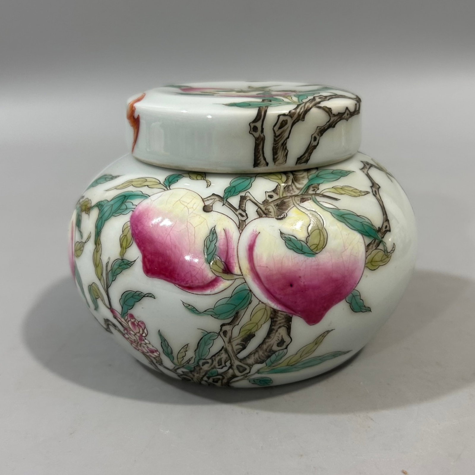 An Exquisite Famille-Rose Bats and Peach Pattern Cover Jar: Estimated Value:1600-3200 An Exquisite Famille-Rose Bats and Peach Pattern Cover Jar,Qing Dynasty,China,Yongzheng Four-character Mark,Size:3.3inx3.7in