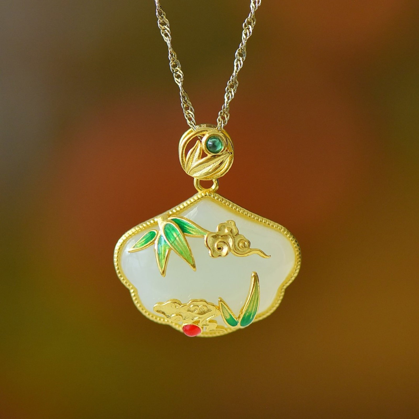 An Exquisite Sterling Silver-Gold Plated Inlaid White Jade Pendant: Estimated Value:300-600 An Exquisite Sterling Silver-Gold Plated Inlaid White Jade Pendant 纯银镀金镶白玉吊坠