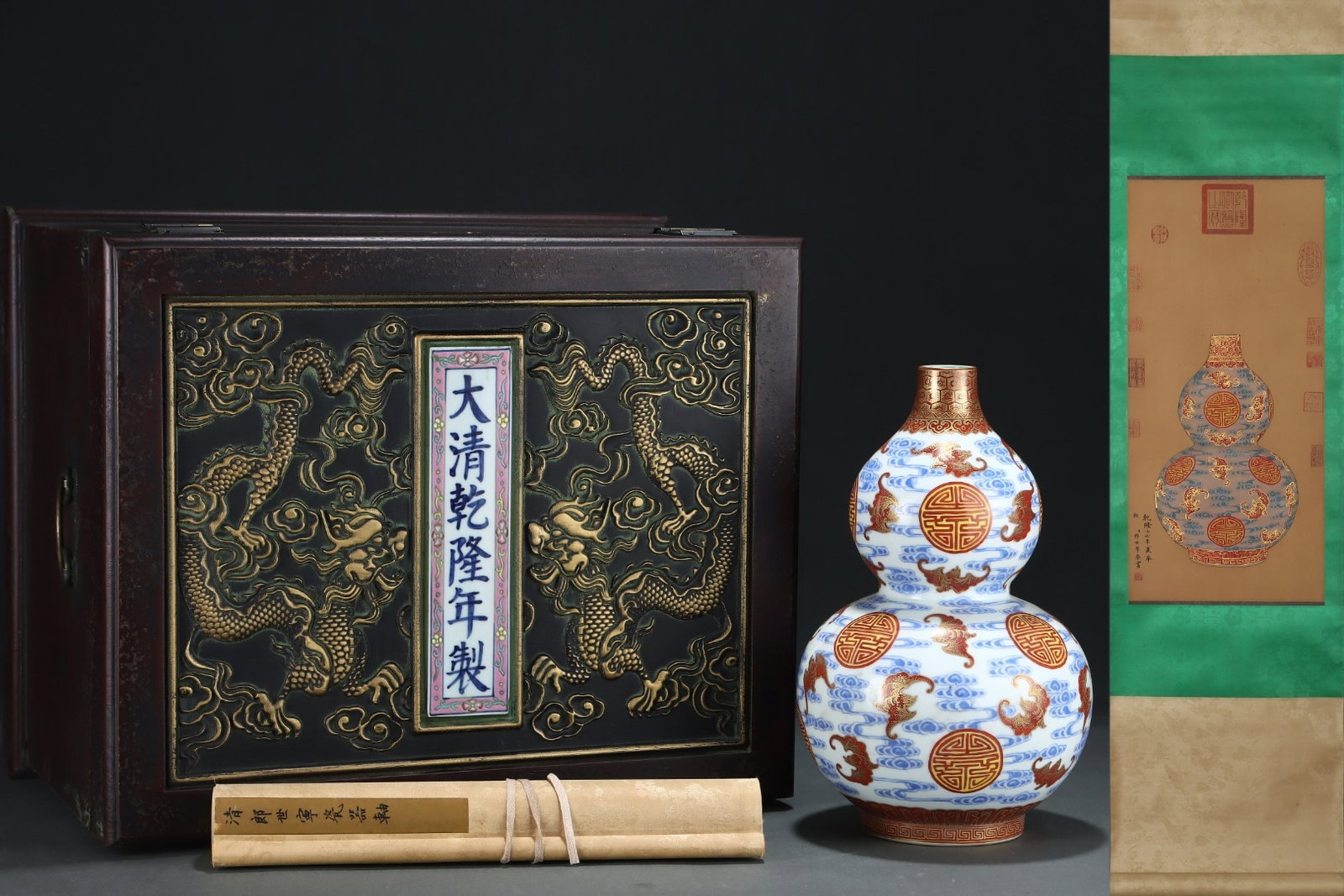 A Rare Blue and White Iron-Red Painted Gold Auspicious Cloud,Bats and Peach Pattern Gourd Vase,With: Estimated Value:8000-16000 A Rare Blue and White Iron-Red Painted Gold Auspicious Cloud,Bats and Peach Pattern Gourd Vase,With Vertical Scroll Painting on Silk,Qing Dynasty, China,Qianlong