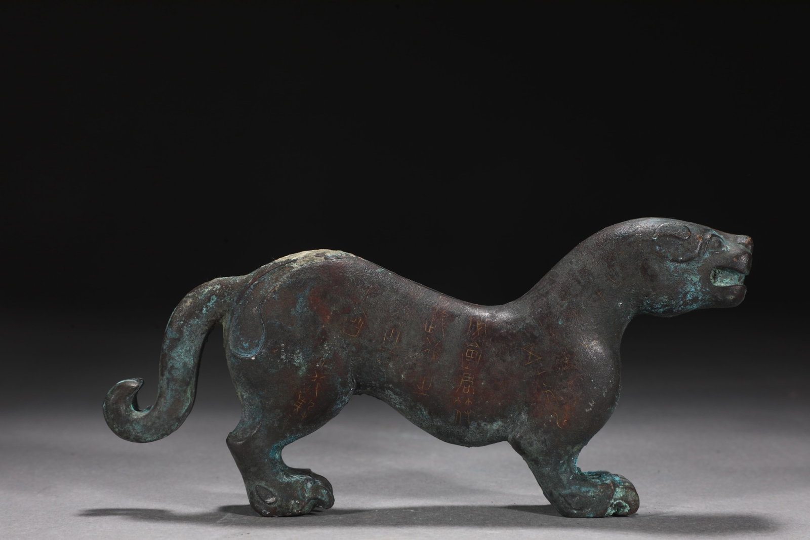 An Exquisite Bronze Inlaid Silver Tiger Ornament,With Inscription: An Exquisite Bronze Inlaid Silver Tiger Ornament,With Inscription,the Warring States period in China,Size:3.2inx7.2in,Weight:1300g