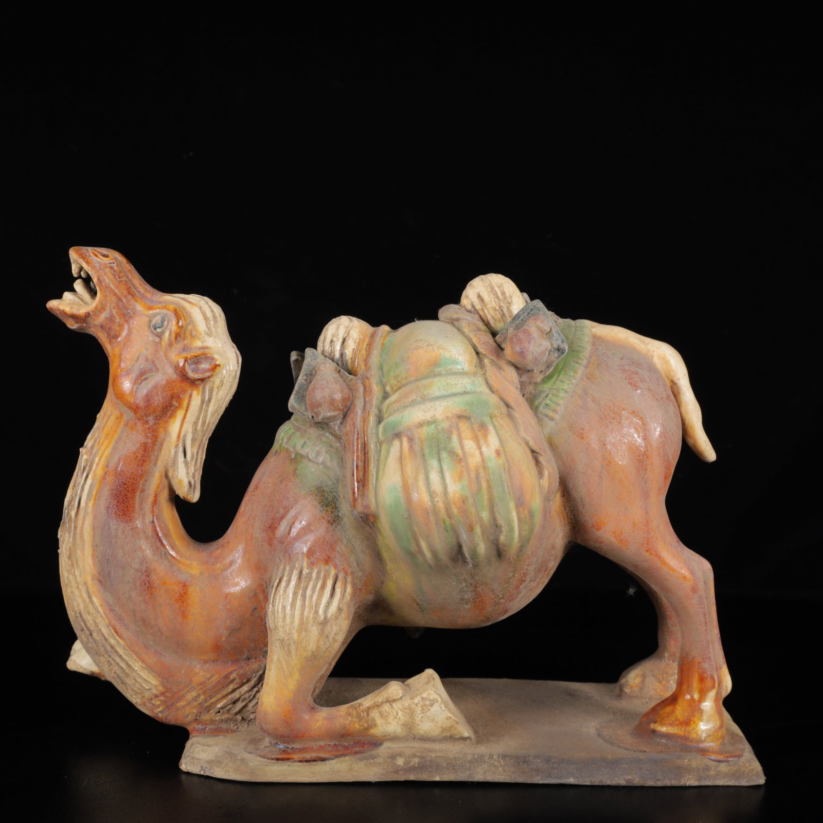 An Exquisite Tang Tri-Color Glazed Pottery Camel Ornament: An Exquisite Tang Tri-Color Glazed Pottery Camel Ornament,Tang Dynasty,China,Size:7.5inx10.2inx5.1in,Weight:1640g