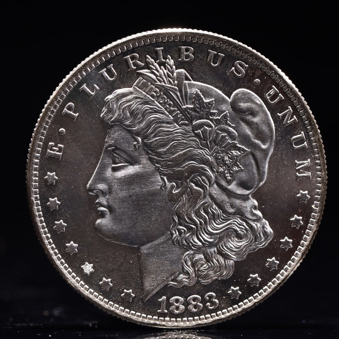 USA Morgan Dollar 1883 Coin: Obv: profile bust with date below and E PLURIBUS UNUM legend and stars around. Rev: eagle with In God we trust above within wreath with UNITED STATES OF AMERICA ONE DOLLAR legend. IN GOD WE TRUST /