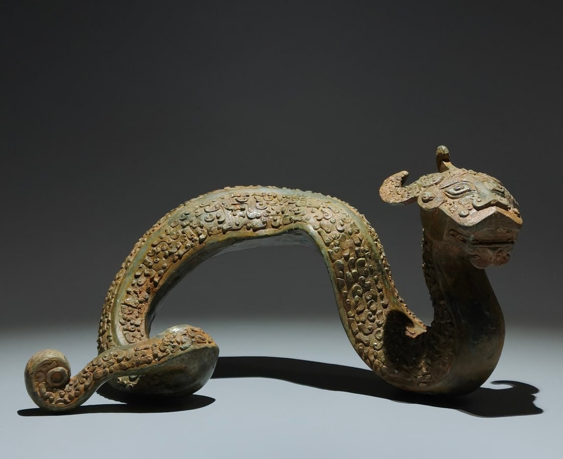 An Archaic Bronze Dragon Ornament: An Archaic Bronze Dragon Ornament,the Warring States period in China,Size:6.9inx12.6inx2.4in 青铜龙摆件,中国战国时期