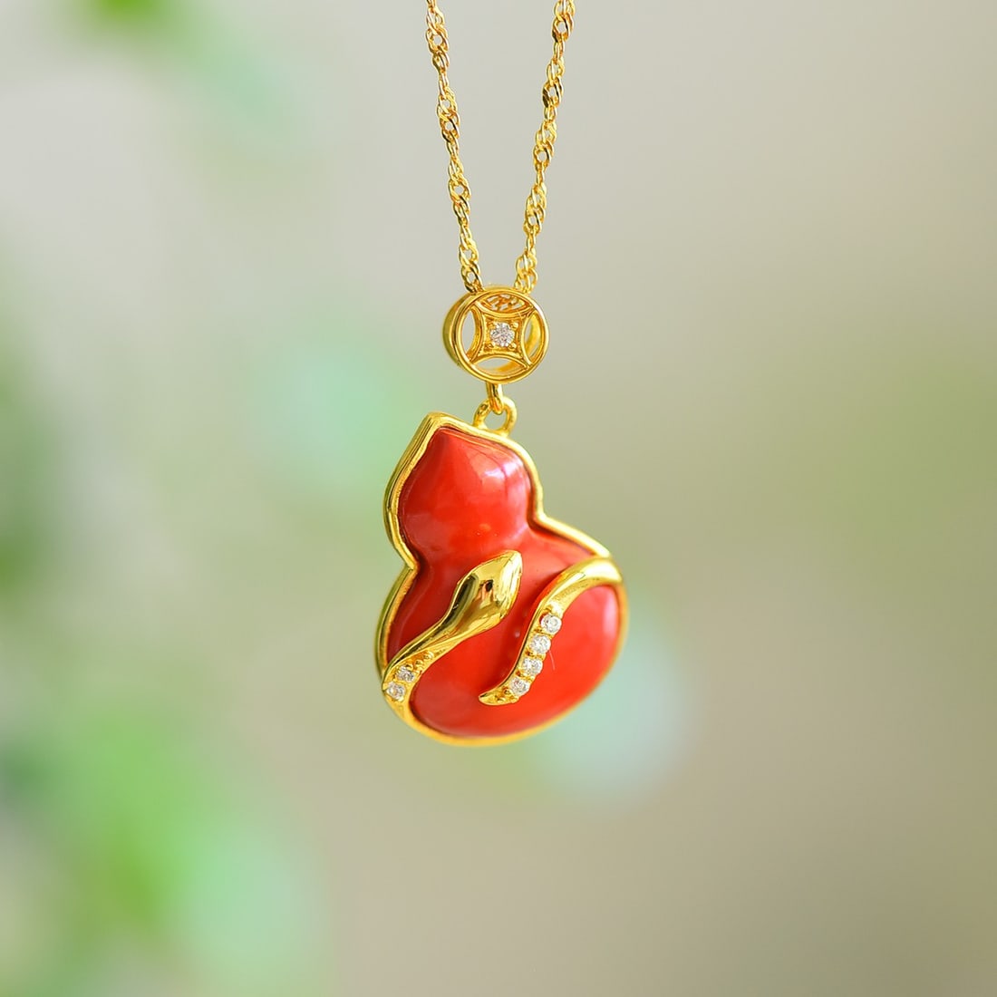 An Exquisite Sterling Silver-Gold Plated Inlaid Cinnabar Gourd Pendant,Inlaid Diamond: An Exquisite Sterling Silver-Gold Plated Inlaid Cinnabar Gourd Pendant,Inlaid Diamond,Size:0.6inx0.8in 寓意:��蛇来运转,灵蛇守护