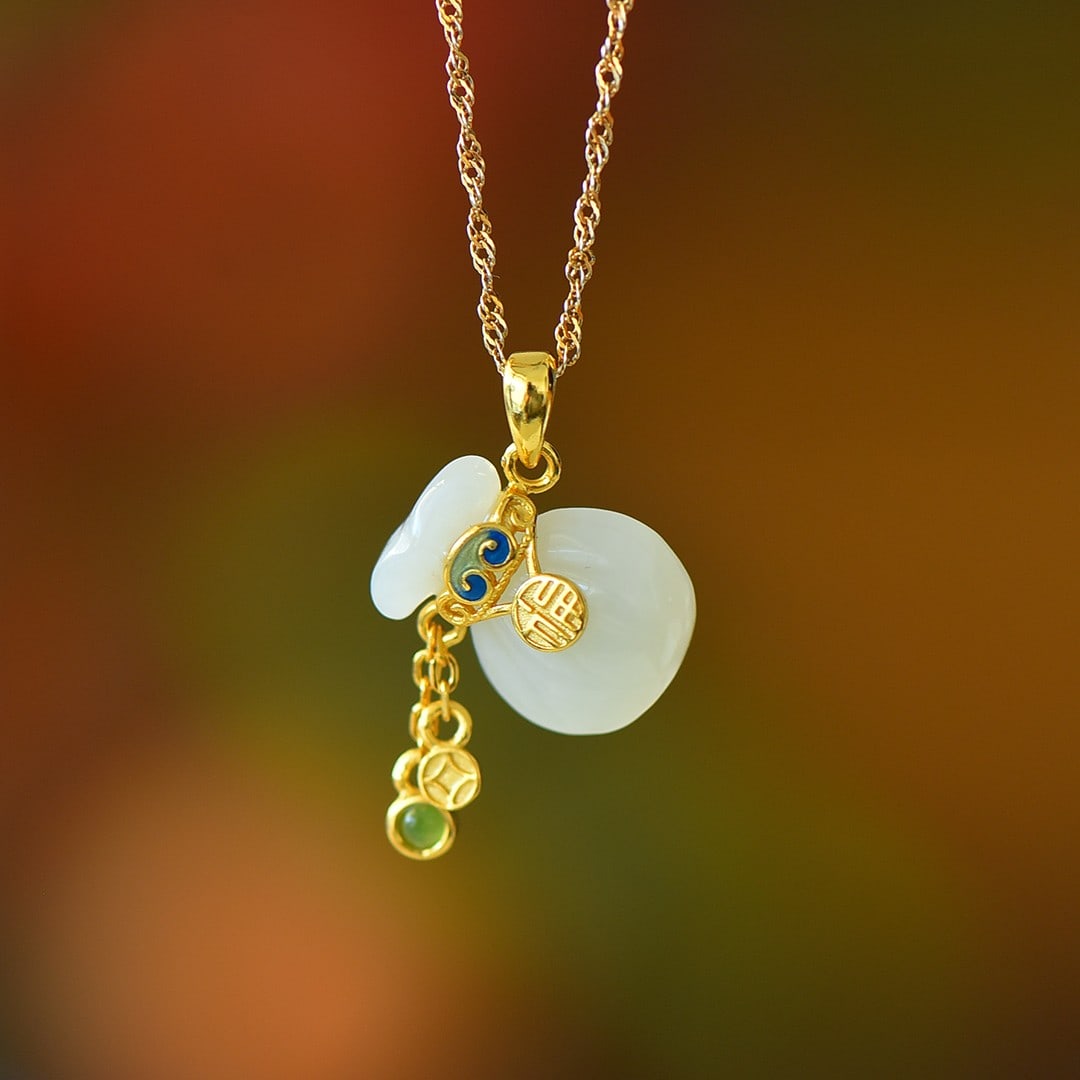 An Exquisite Sterling Silver-Gold Plated Inlaid White Jade Pendant: An Exquisite Sterling Silver-Gold Plated Inlaid White Jade Pendant,Size:0.5inx0.6in 纯银镀金镶白玉吊坠