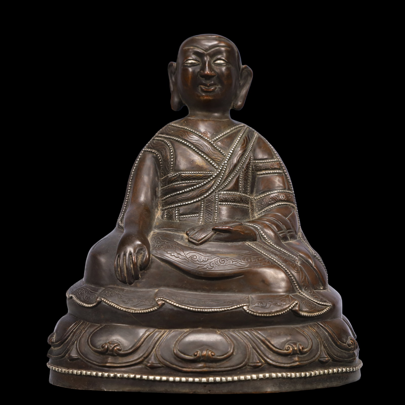 An Exquisite Bronze Inlaid Silver Statue of Guru: An Exquisite Bronze Inlaid Silver Statue of Guru Ming Dynasty, China Size:7.1inx5.9inx7.5in Weight:2800g铜嵌银上师佛像 中国明代 Size:1