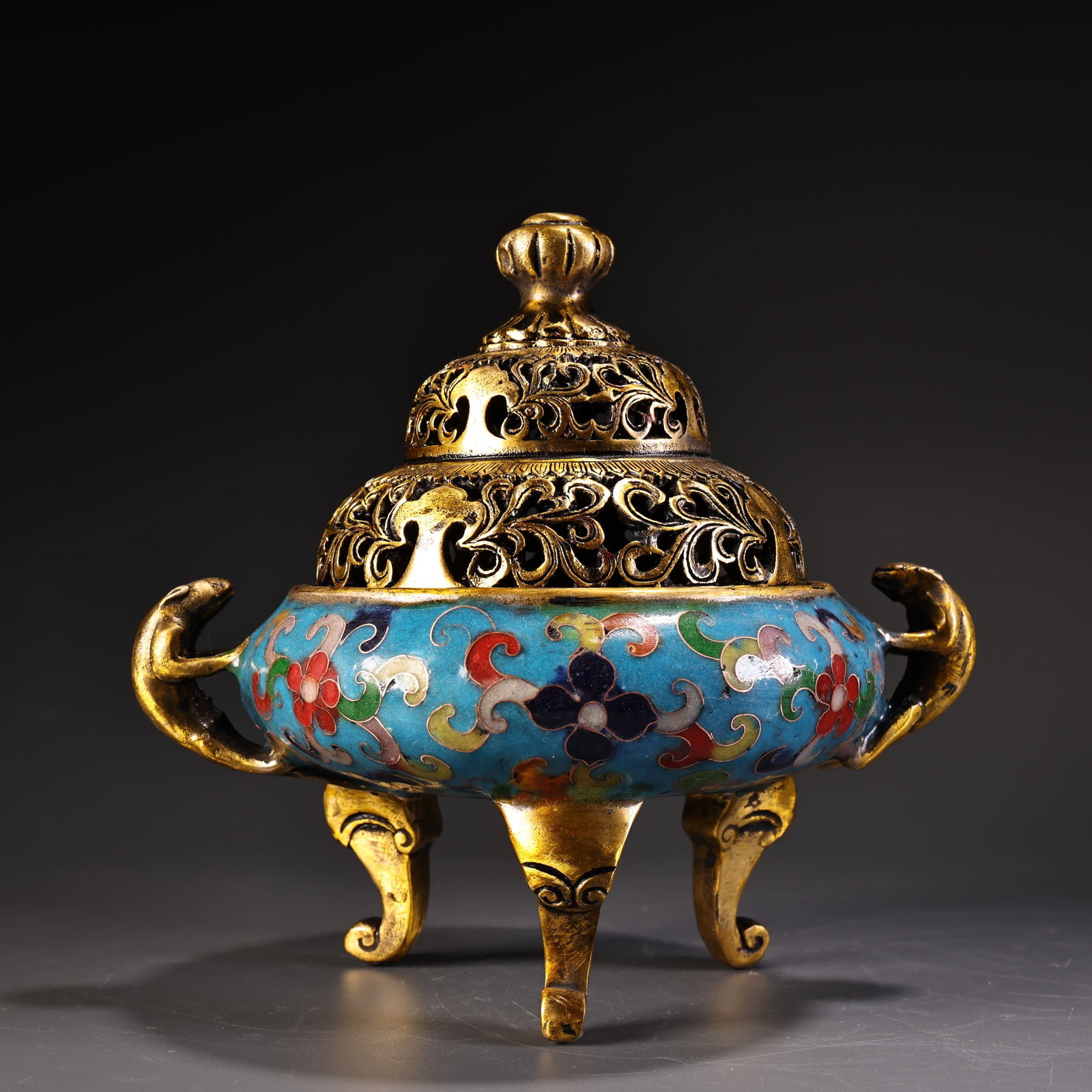 An Exquisite Gilt Bronze Inlaid Cloisonne Double-Ears and Tripod Censer: An Exquisite Gilt Bronze Inlaid Cloisonne Double-Ears and Tripod Censer Qing Dynasty, China Qianlong Four-character Mark Size:6.3inx6.3in Weight:900g铜鎏金景泰蓝