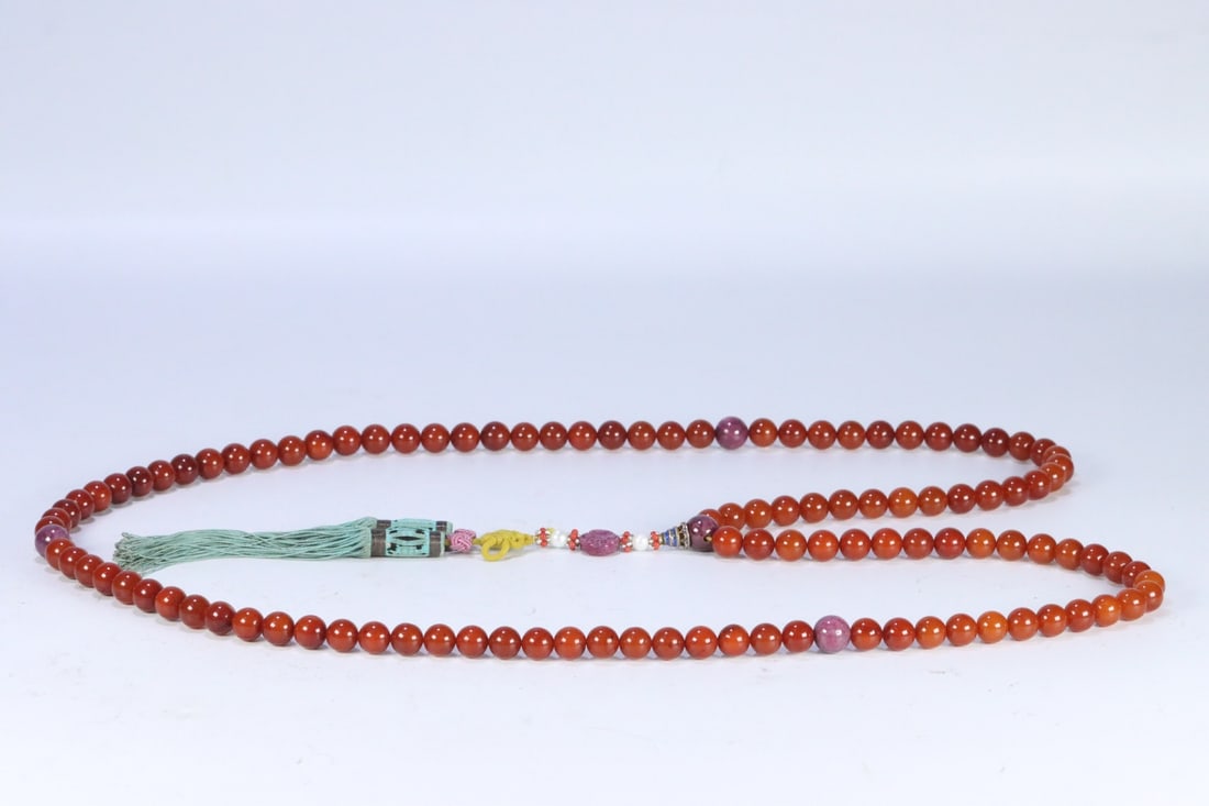 An Exquisite Ruby Inlaid Amber Bracelets: An Exquisite Ruby Inlaid Amber Bracelets Qing Dynasty, China Size:0.4in Weight:110.5g红宝石蜜蜡108佛珠 中国清代 Size:1.1cm Weight:110.