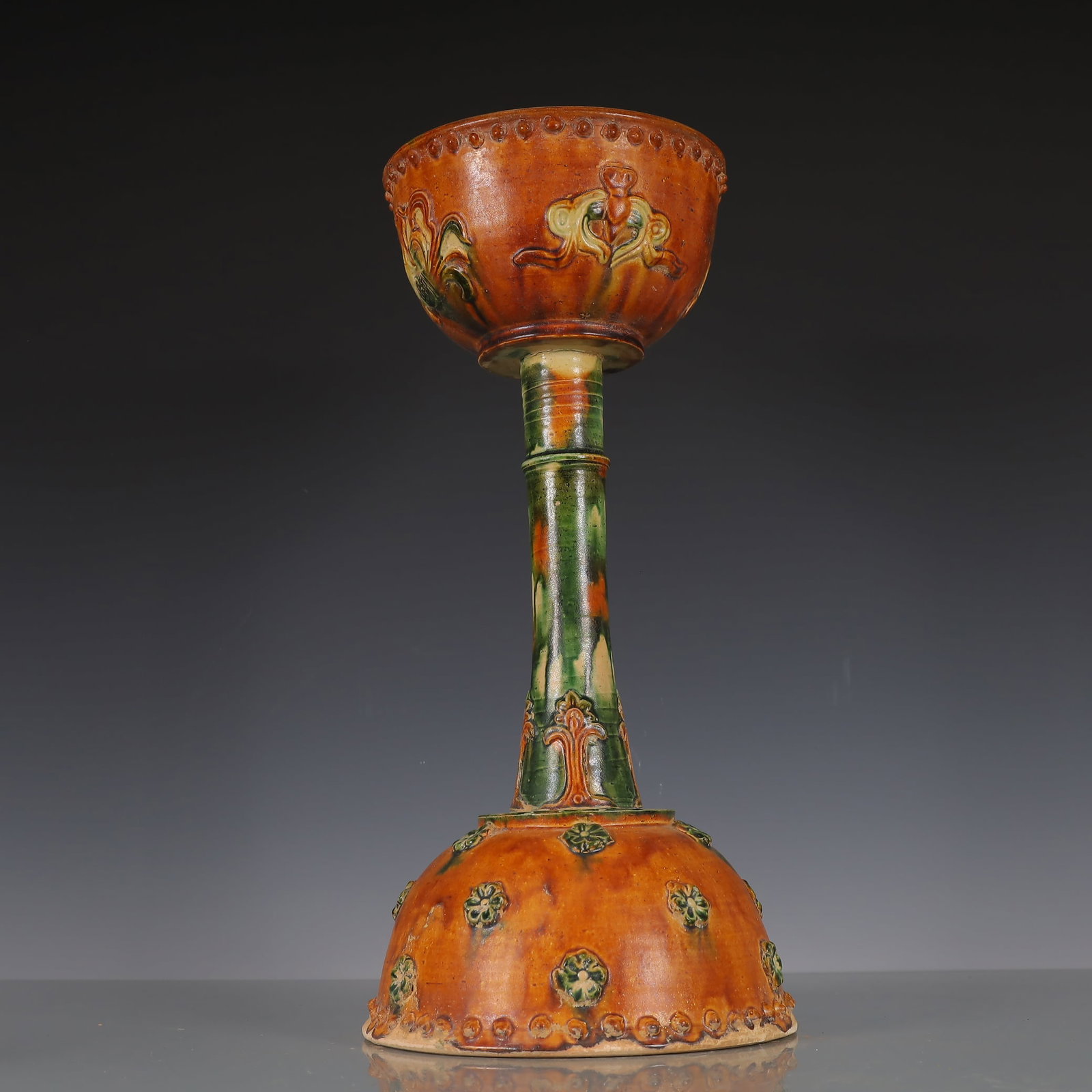 A Exquisite Trio-colored glazed pottery of the Tang Dynasty Flower Pattern Candlestick: A Exquisite Trio-colored glazed pottery of the Tang Dynasty Flower Pattern Candlestick Tang Dynasty, China Size:8.7inx8.7inx17.9in Weight:2650g唐三彩花卉纹烛&