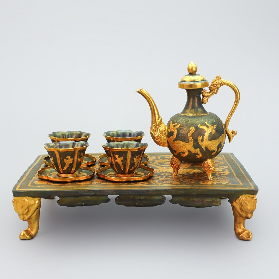 A Set of Fine Gilt Bronze Auspicious Beast Pattern Teapot Cup: A Set of Fine Gilt Bronze Auspicious Beast Pattern Teapot Cup Tang Dynasty, China Zhenguan Four-character Mark Size:8.7inx10.9inx7.9in Weight:1395g錾刻铜鎏金茶Ð