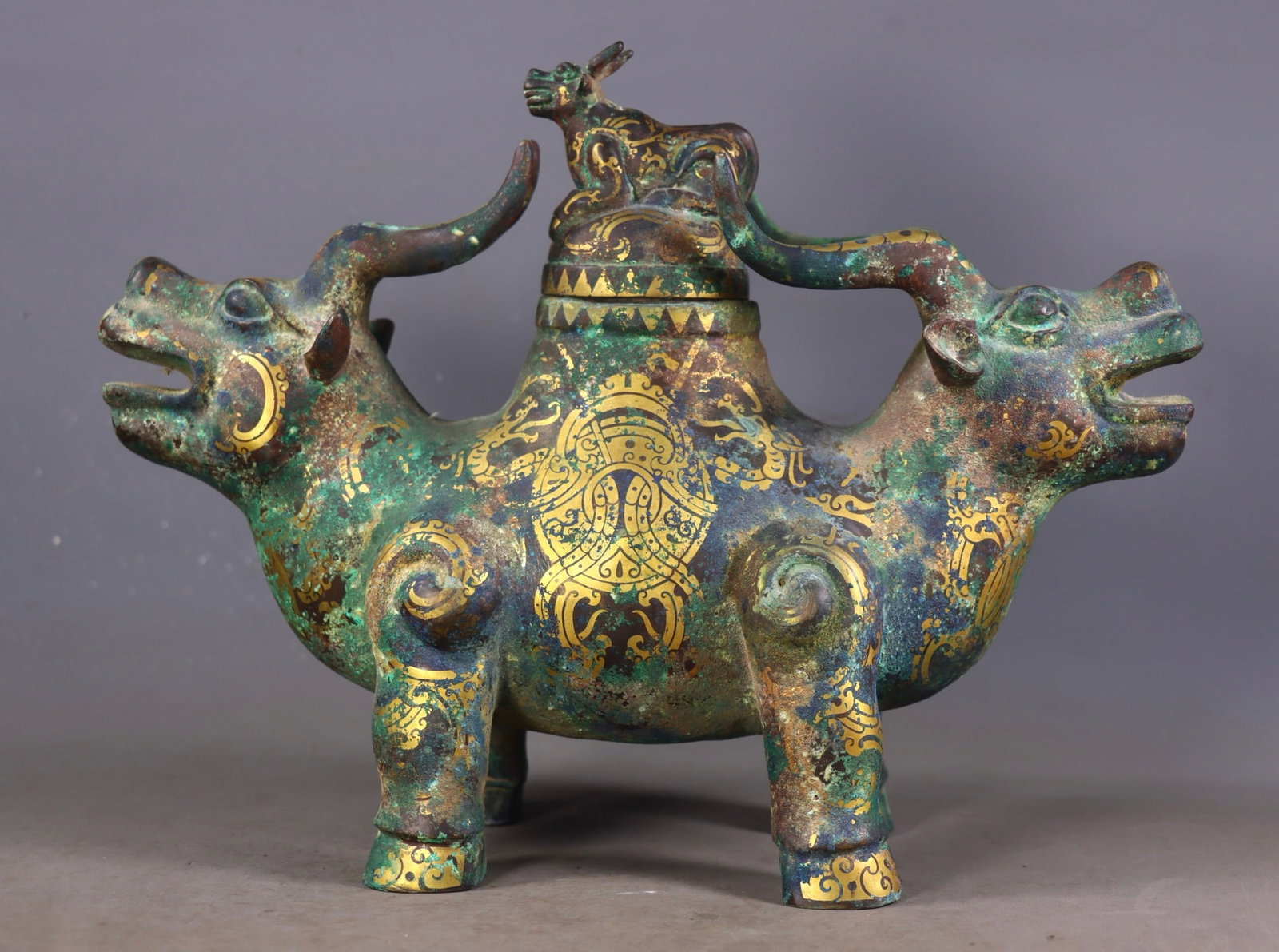 An Exquisite Bronze Inlaid Gold and Silver Auspicious Beast-Shaped Censer: An Exquisite Bronze Inlaid Gold and Silver Auspicious Beast-Shaped Censer Han Dynasty, China Size: 9.8inx12.6inx4.7in
