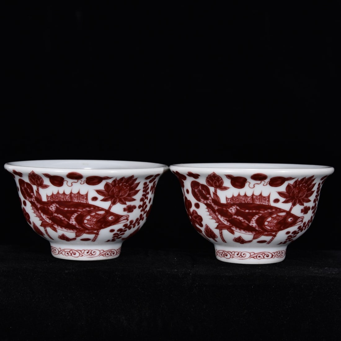 An Exquisite Underglaze-Red Fish and Lotus Pattern Cup: An Exquisite Underglaze-Red Fish and Lotus Pattern Cup Ming Dynasty, China Size:2.2inx3.7in釉里红鱼藻纹压手杯 中国明代