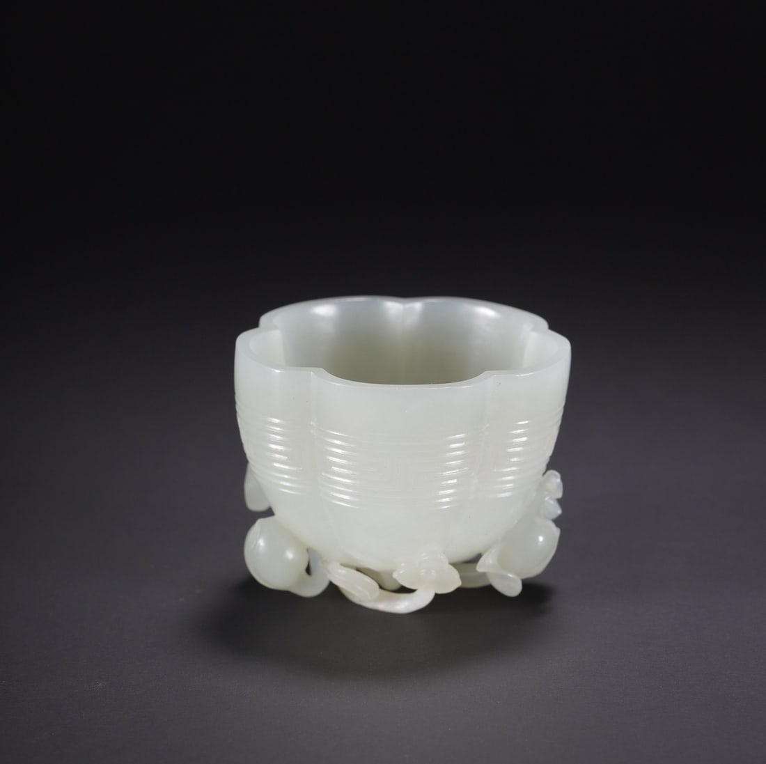 An Exquisite White Jade Flower Pattern Cup: An Exquisite White Jade Flower Pattern Cup Qing Dynasty, China Diameter Size:2.2in Size:1.8in Weight:68.2g白玉莲花杯 中国清代 Diameter Size:5.5cm