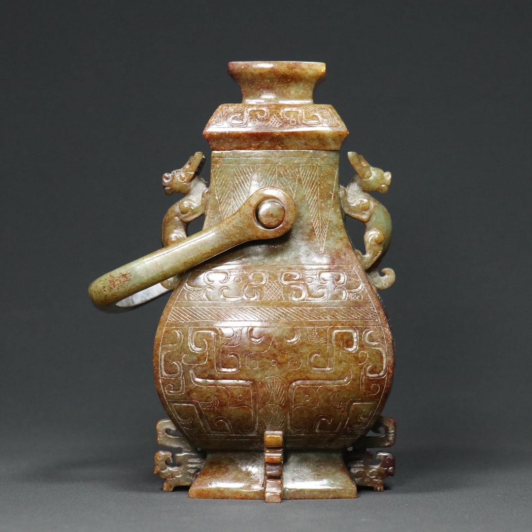 An Exquisite White Jade Dragon Pattern Beast-Face Pattern Double-Ears Vase Ornament: An Exquisite White Jade Dragon Pattern Beast-Face Pattern Double-Ears Vase Ornament Han Dynasty, China Size:7.7inx3.9inx3.1in