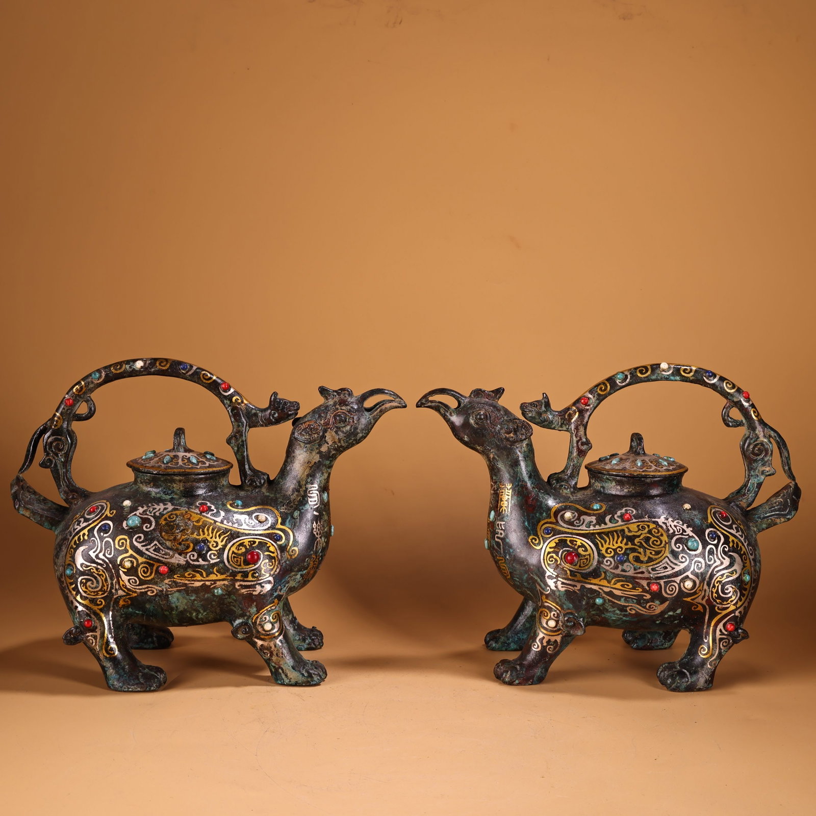 A Pair of Exquisite Bronze Inlaid Gold and Silver Inlaid Gems With Inscription Auspicious: A Pair of Exquisite Bronze Inlaid Gold and Silver Inlaid Gems With Inscription Auspicious Beast-Shaped Ewer Han Dynasty, China Size:7.5inx6.3in Weight:2000g错金银镶嵌