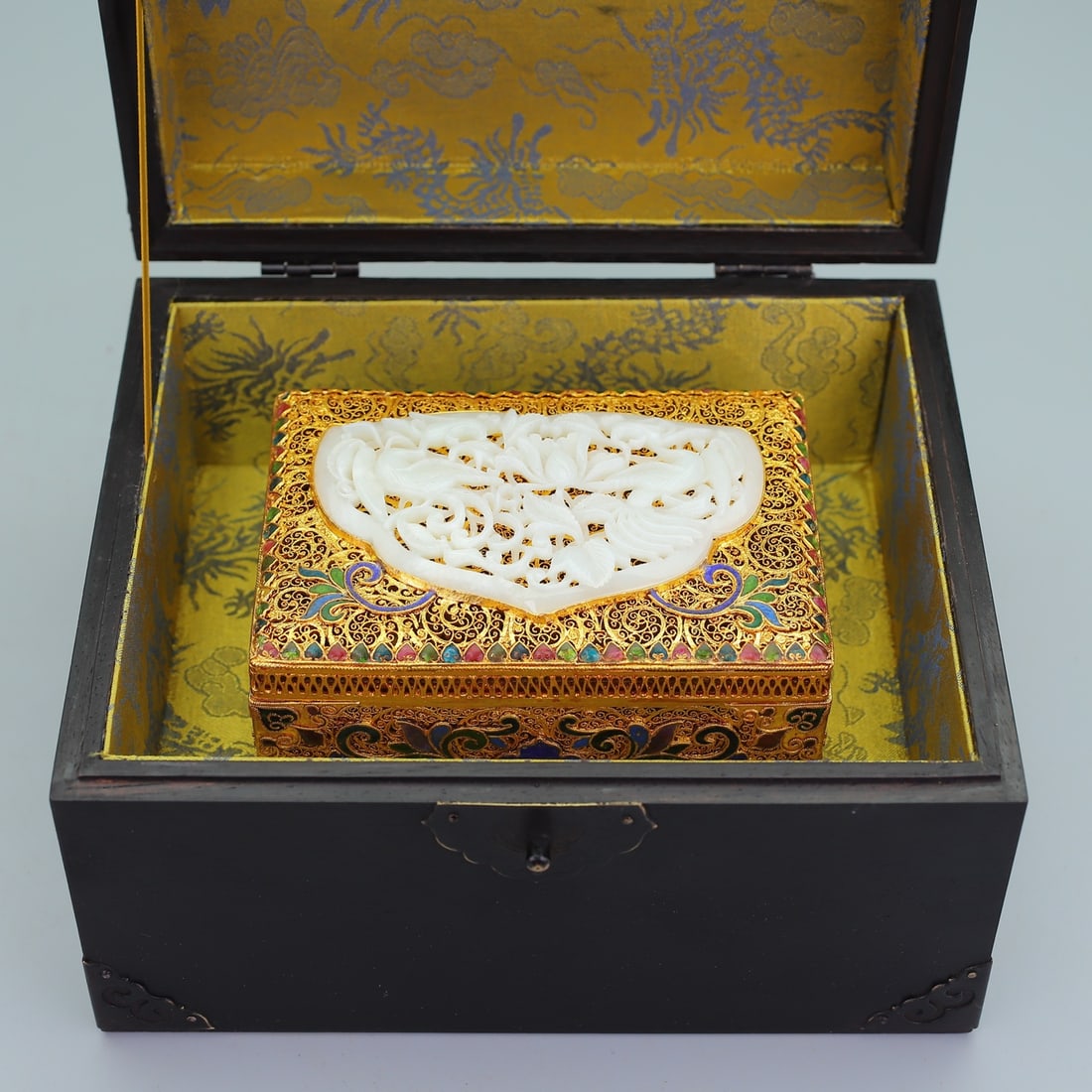 An Exquisite Gilt Bronze Inlaid White Jade Flower and Bird Pattern Box: An Exquisite Gilt Bronze Inlaid White Jade Flower and Bird Pattern Box Qing Dynasty, China Qianlong Four-character Mark Size:5.5inx8.7in Weight:1950g Size:3.1inx5.5in