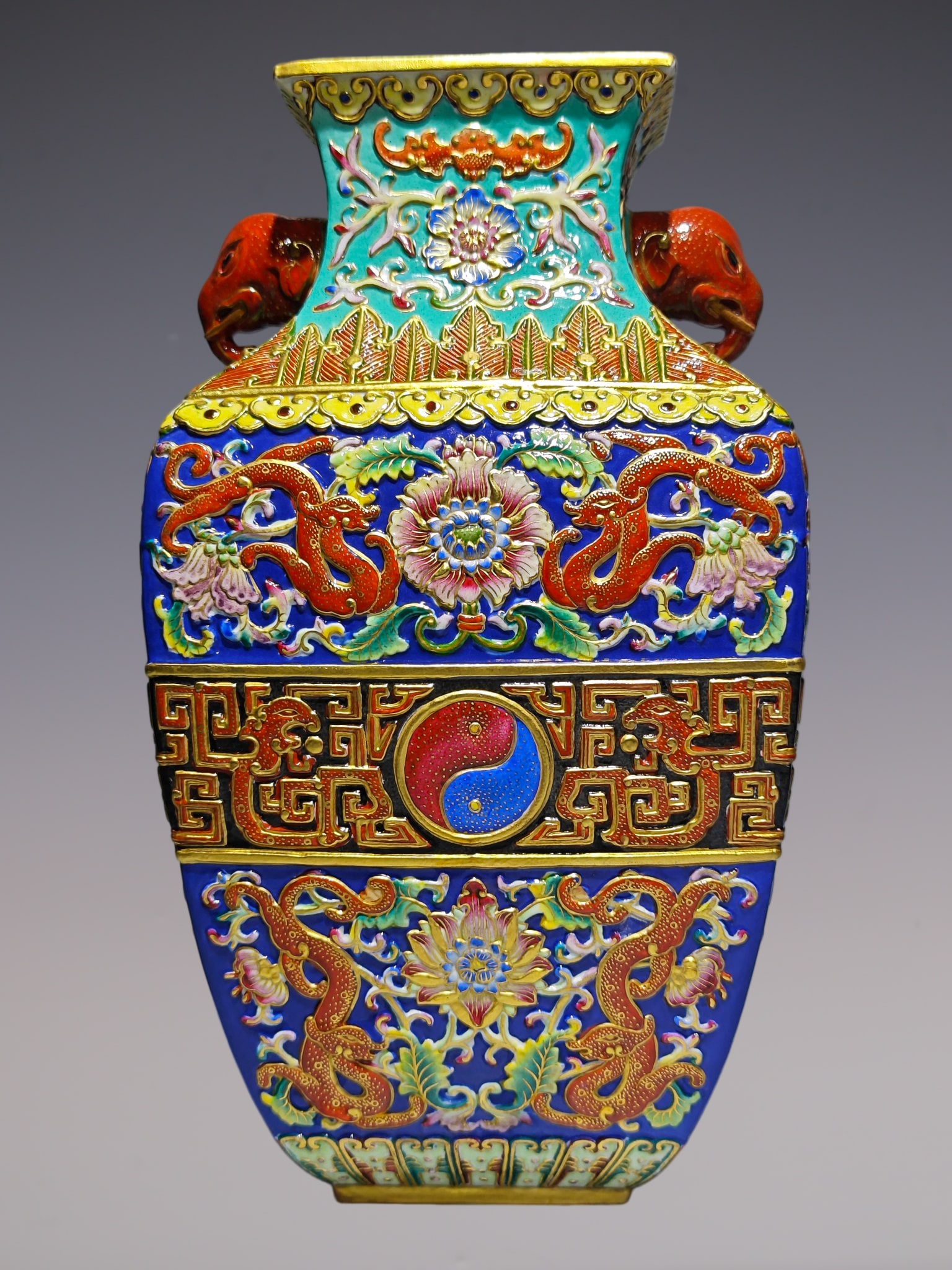 An Exquisite Enamel Lotus Pattern Dragon Pattern Double-Ears Vase: An Exquisite Enamel Lotus Pattern Dragon Pattern Double-Ears Vase Qing Dynasty, China Qianlong Six-character Mark Size:10.6inx6in珐琅彩浮雕夔龙穿缠