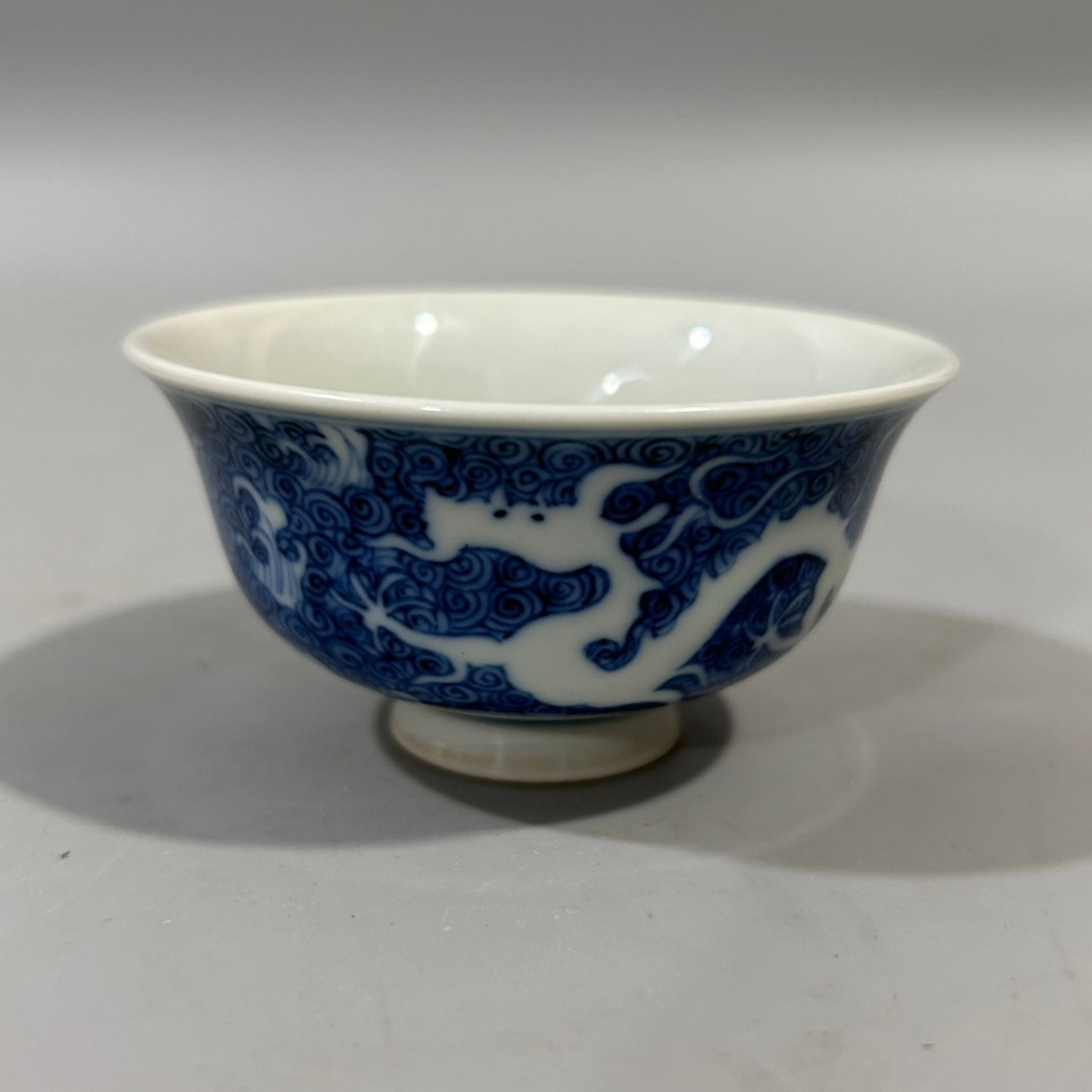 An Exquisite Blue and White Seawater and Dragon Pattern Cup: An Exquisite Blue and White Seawater and Dragon Pattern Cup,Qing Dynasty,China,Yongzheng Six-character Mark,Size:3.1inx1.8in 青花海水龙纹杯,中国&#