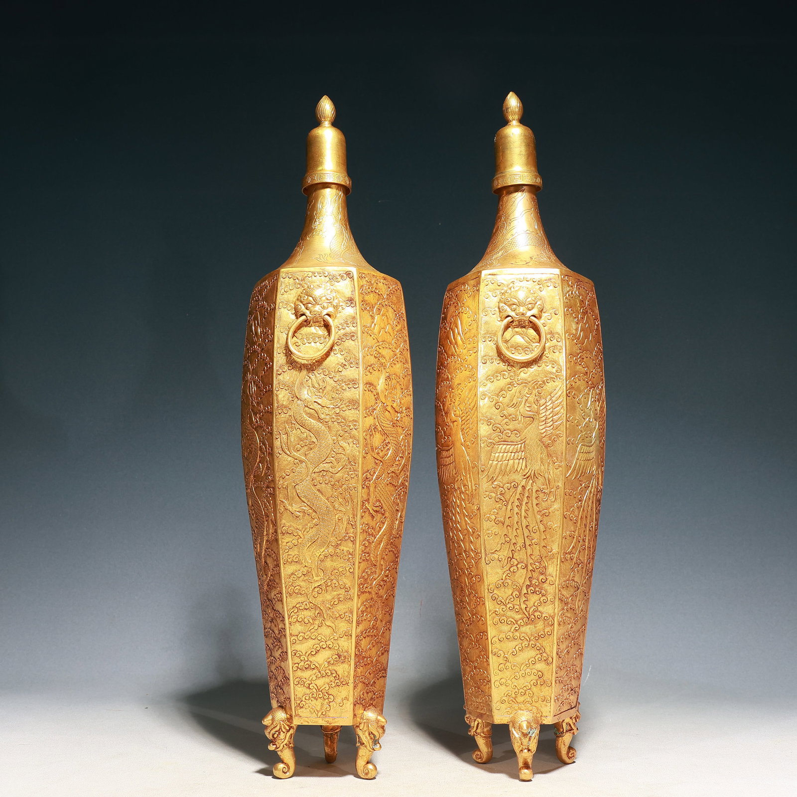 A Pair of Huge Gilt Bronze Dragon and Phoenix Pattern Lion-Ears Tripod Bottles: A Pair of Huge Gilt Bronze Dragon and Phoenix Pattern Lion-Ears Tripod Bottles,Qing Dynasty, China,Size:4.7inx20.5in,Weight:4050g 一对铜鎏金龙凤纹୾