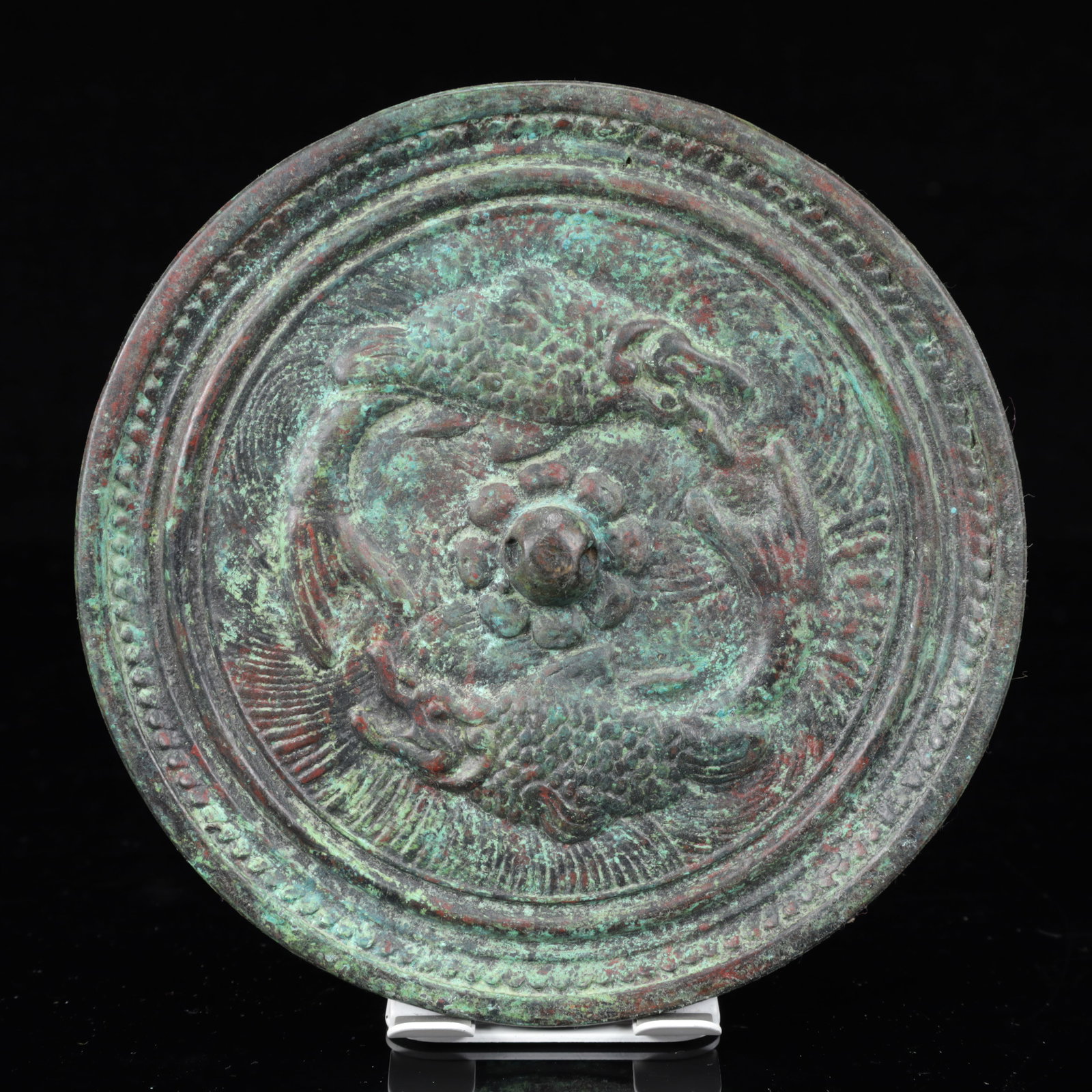 An Archaic Bronze Fish Pattern Round Mirror: An Archaic Bronze Fish Pattern Round Mirror,The Warring States period in China,Size:6.5inx0.6in,Weight:950g 青铜鱼纹圆镜,中国战国时