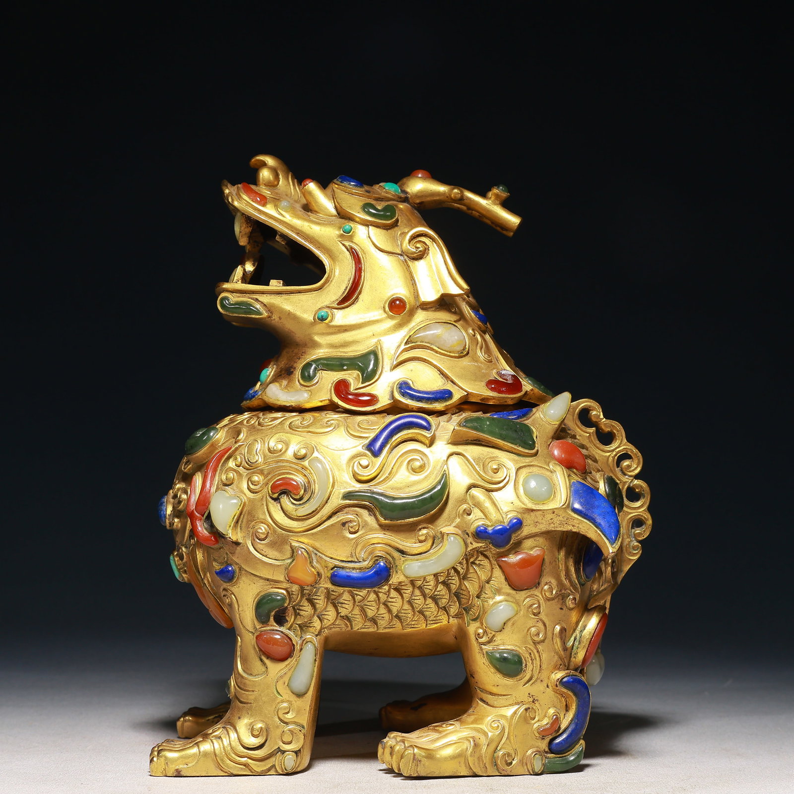 An Exquisite Gilt Bronze Inlaid Gems Unicorn Ornament: An Exquisite Gilt Bronze Inlaid Gems Unicorn Ornament,Qing Dynasty,China,Size:7.1inx5.1inx9.4in,Weight:5700g 铜鎏金镶百宝独角兽摆件,&#